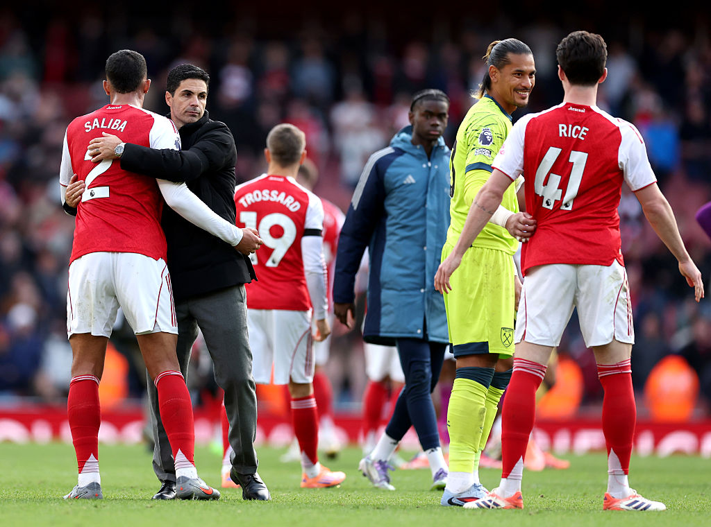 Mikel Arteta, Manager of Arsenal, embraces William Saliba of Arsenal after the team's victory in the Premier League match between Arsenal and West Ham United