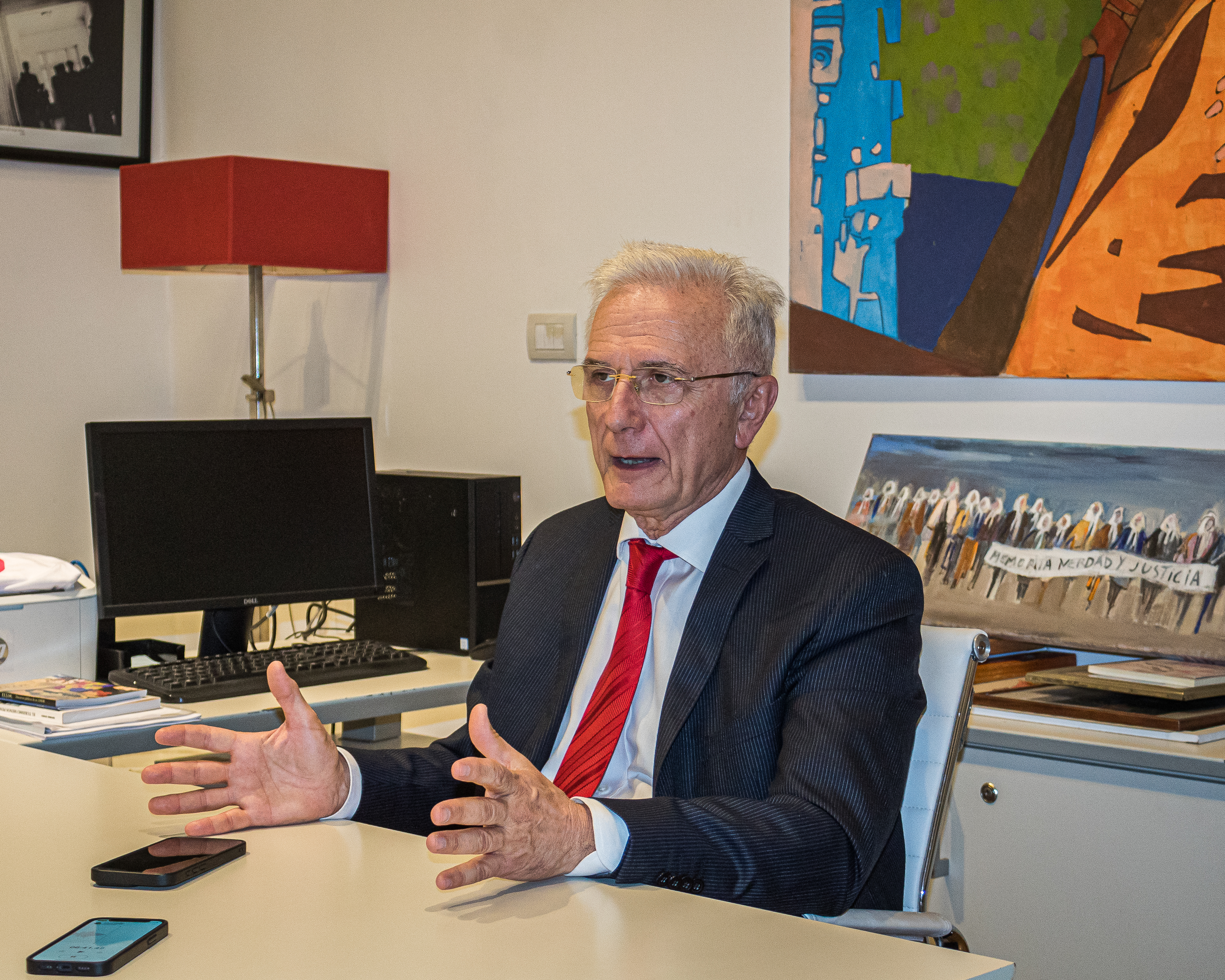 Felix Bardone speaks as he sits behind a desk.