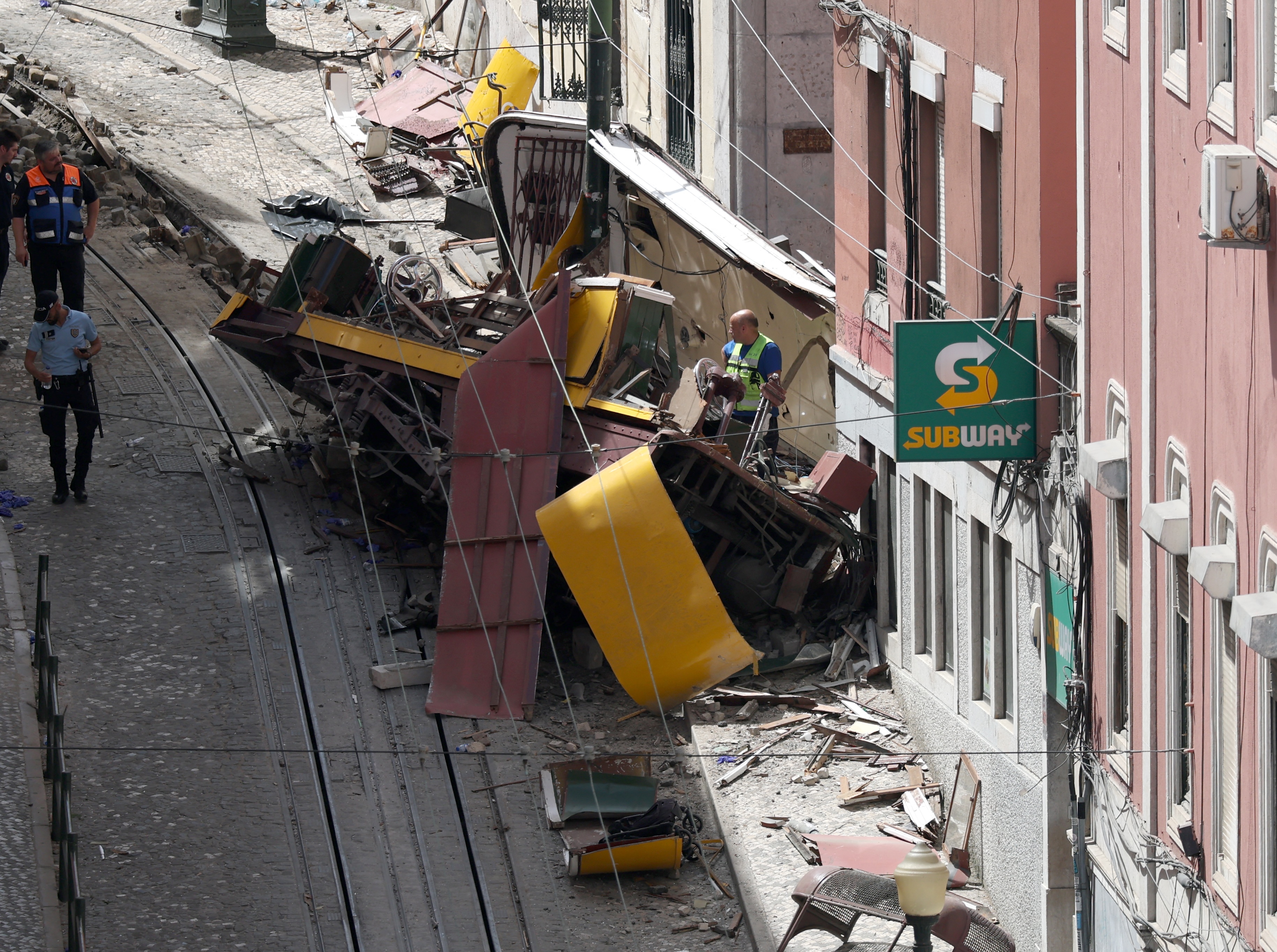 (FILES) Police and civil protection members work on the site of the Gloria funicular accident that killed 16 a day earlier in Lisbon, on September 4, 2025.