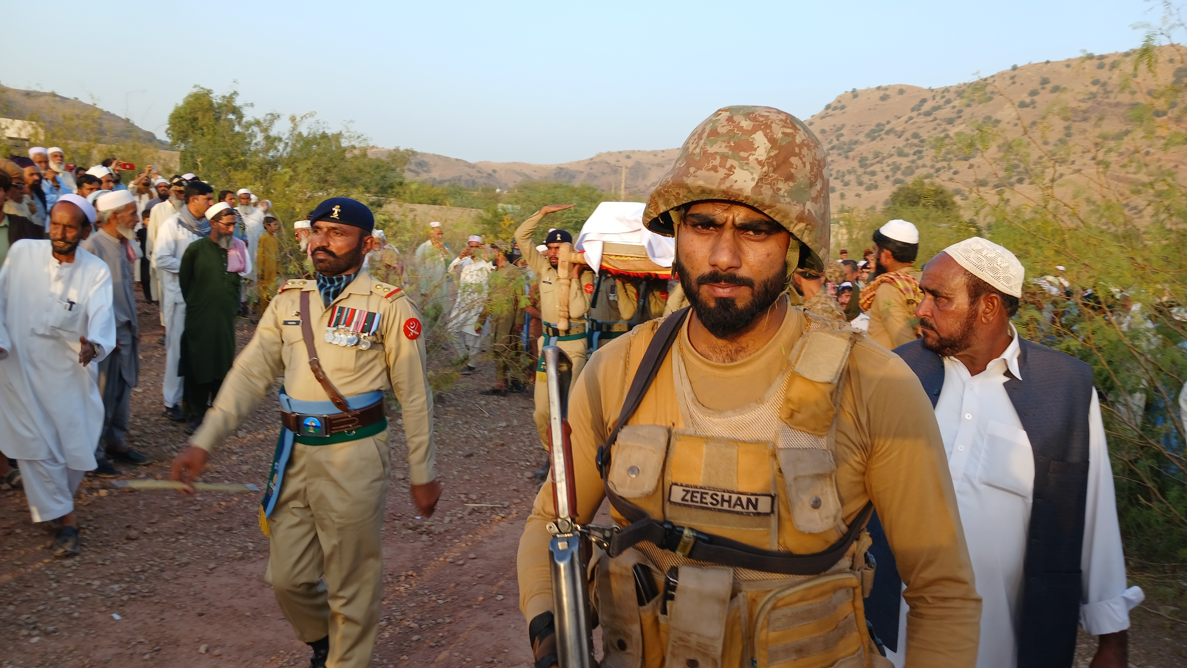Relatives and army personnel attend the funeral of a soldier killed in fighting.
