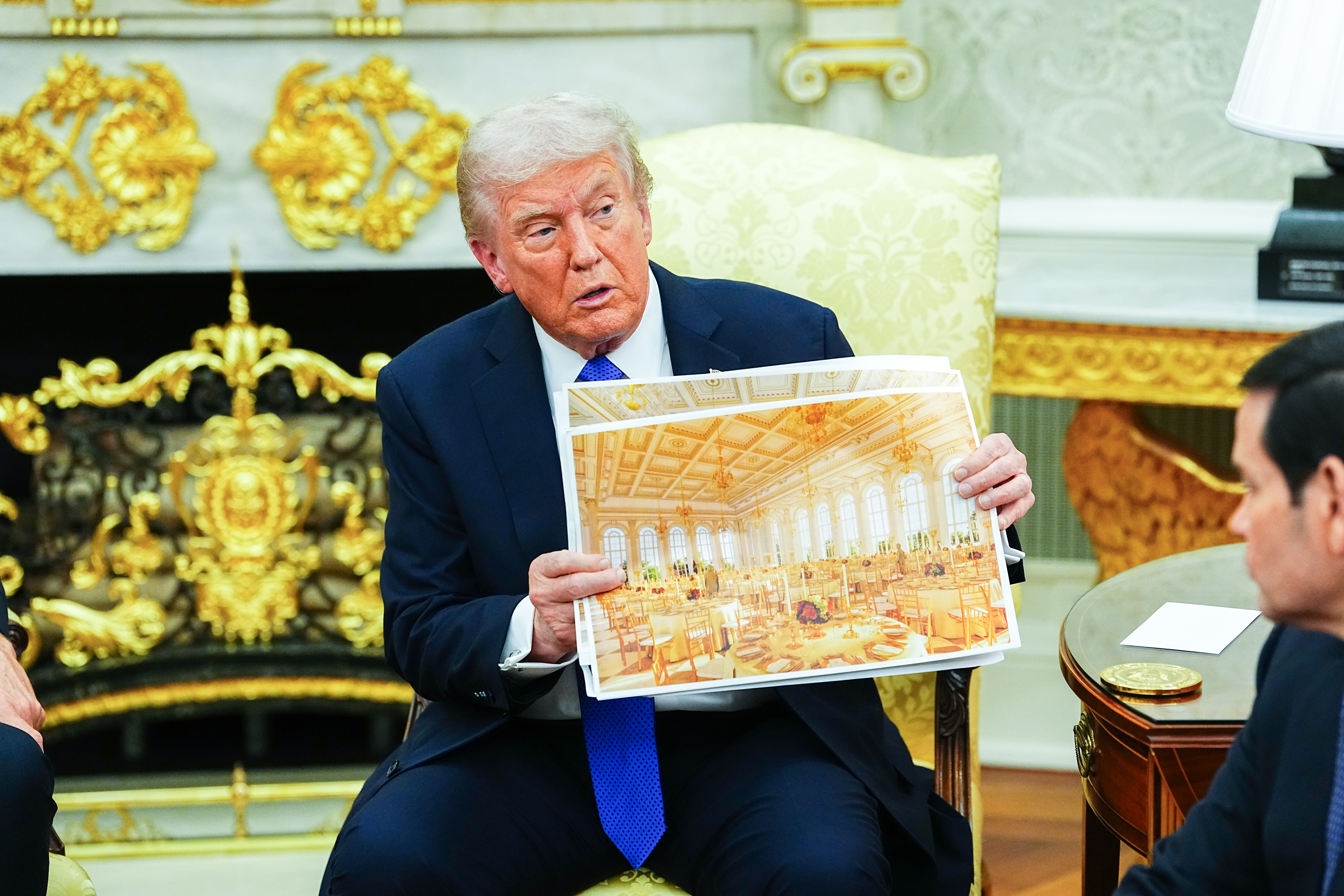 epa12474294 United States President Donald J. Trump shows an interior rendering of the new White House Ballroom as he meets with NATO Secretary General Mark Rutte in the Oval Office of the White House in Washington, DC, USA, 22 October 2025. The leaders met to discuss continued support for Ukraine. EPA/AARON SCHWARTZ / POOL
