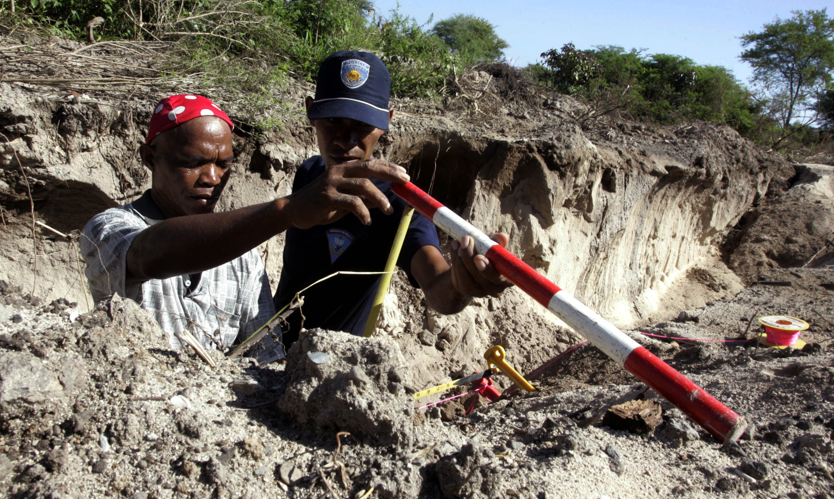 East Timor forensic police check a construction site as they search for more human skeletons in Liquisa on the outskirts of Dili, East Timor March 9, 2010. The construction of a luxury hotel near East Timor's capital has uncovered mass graves containing skeletons of people who may have been killed during the country's occupation by Indonesia, scientists said on Thursday. Picture taken March 9, 2010. REUTERS/Lirio Da Fonseca (EAST TIMOR - Tags: POLITICS CIVIL UNREST)