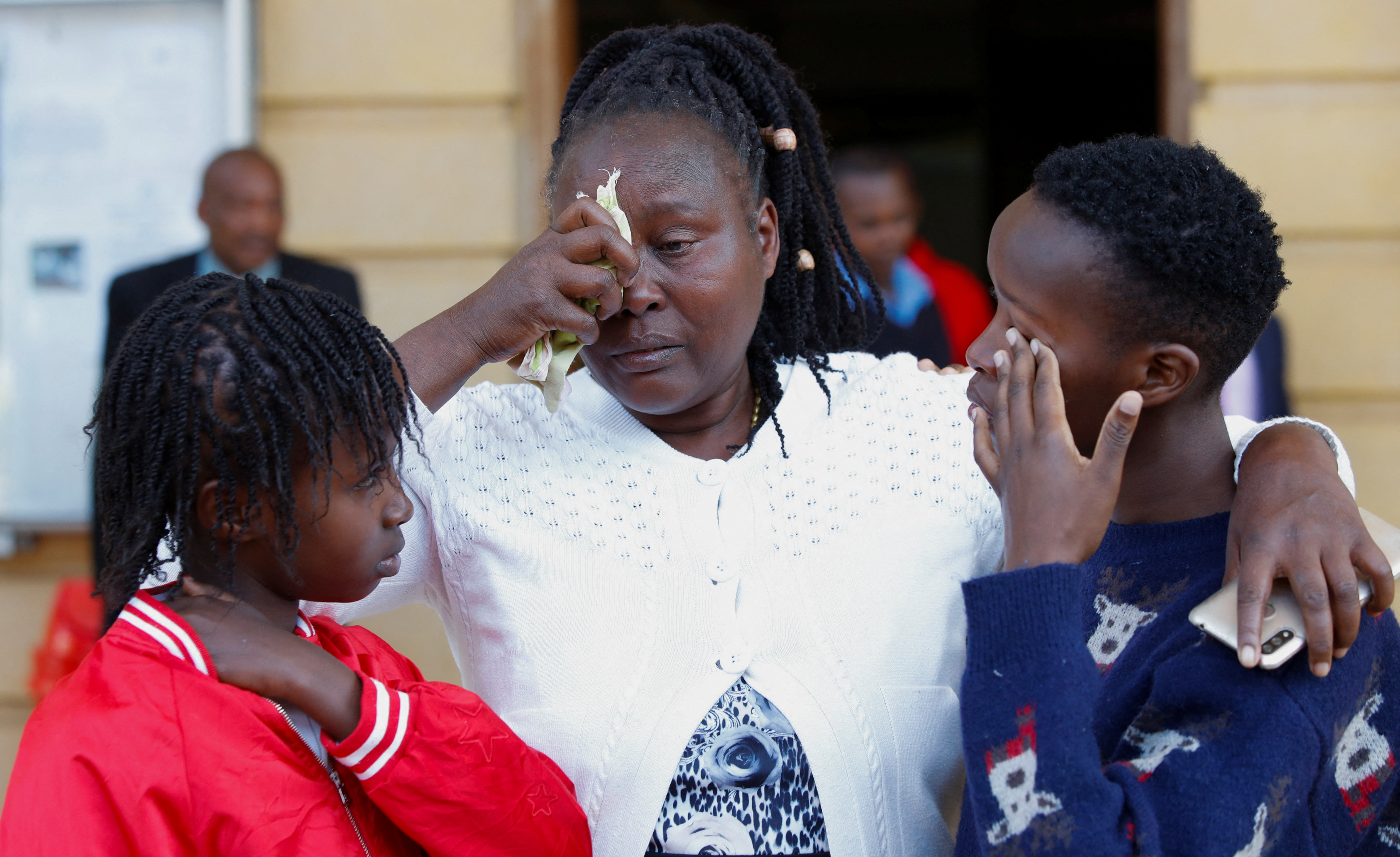 Family members of the late Agnes Wanjiru cry after a court session.