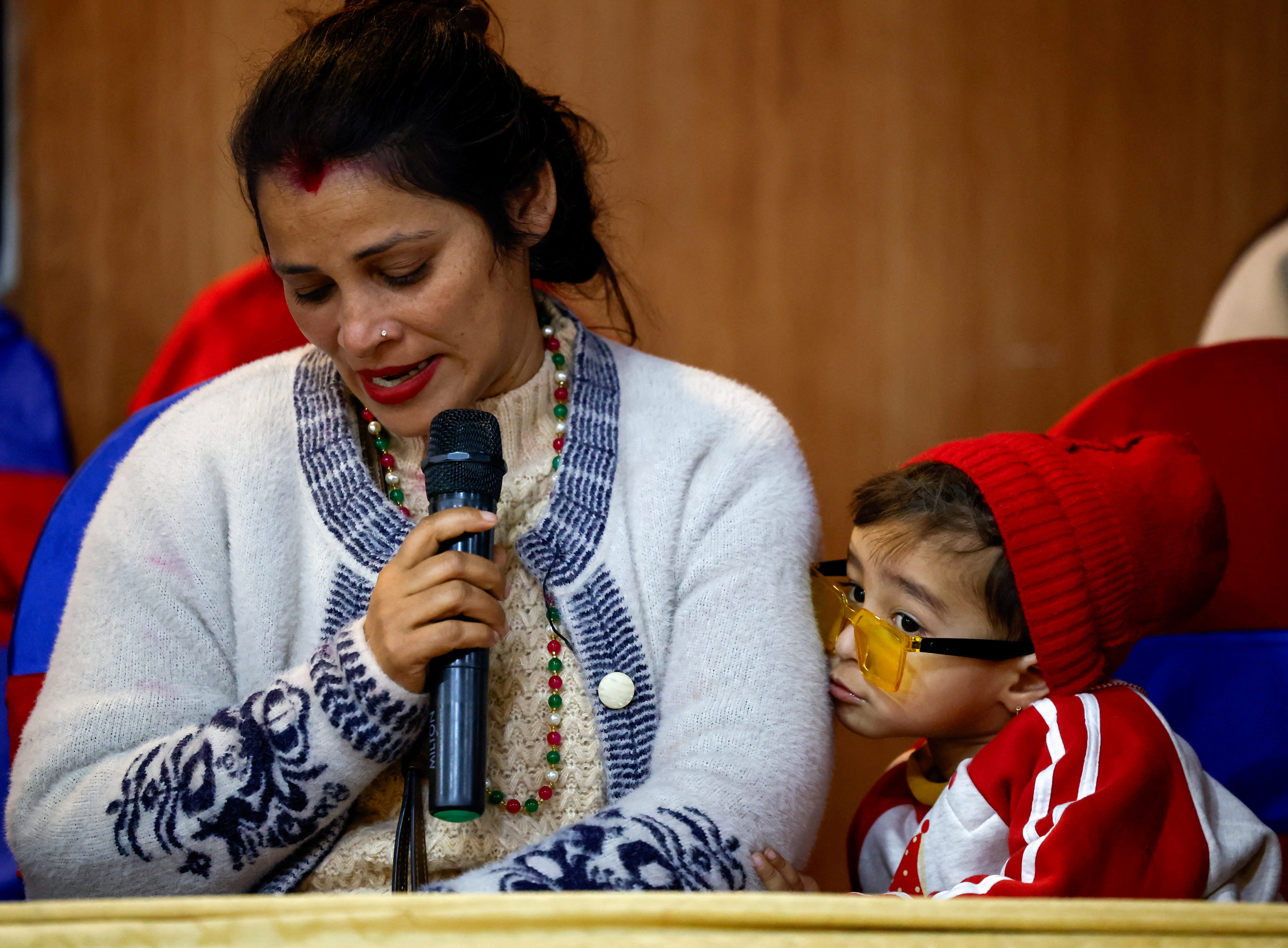 Tina Ghimire, wife of Padam Ghimire, speaks to members of the media about her husband, who is in Russia, as families of Nepali nationals who have been recruited by the Russian army to fight against Ukraine pleaded for their safe return, in Kathmandu, Nepal February 2, 2024. REUTERS/Navesh Chitrakar