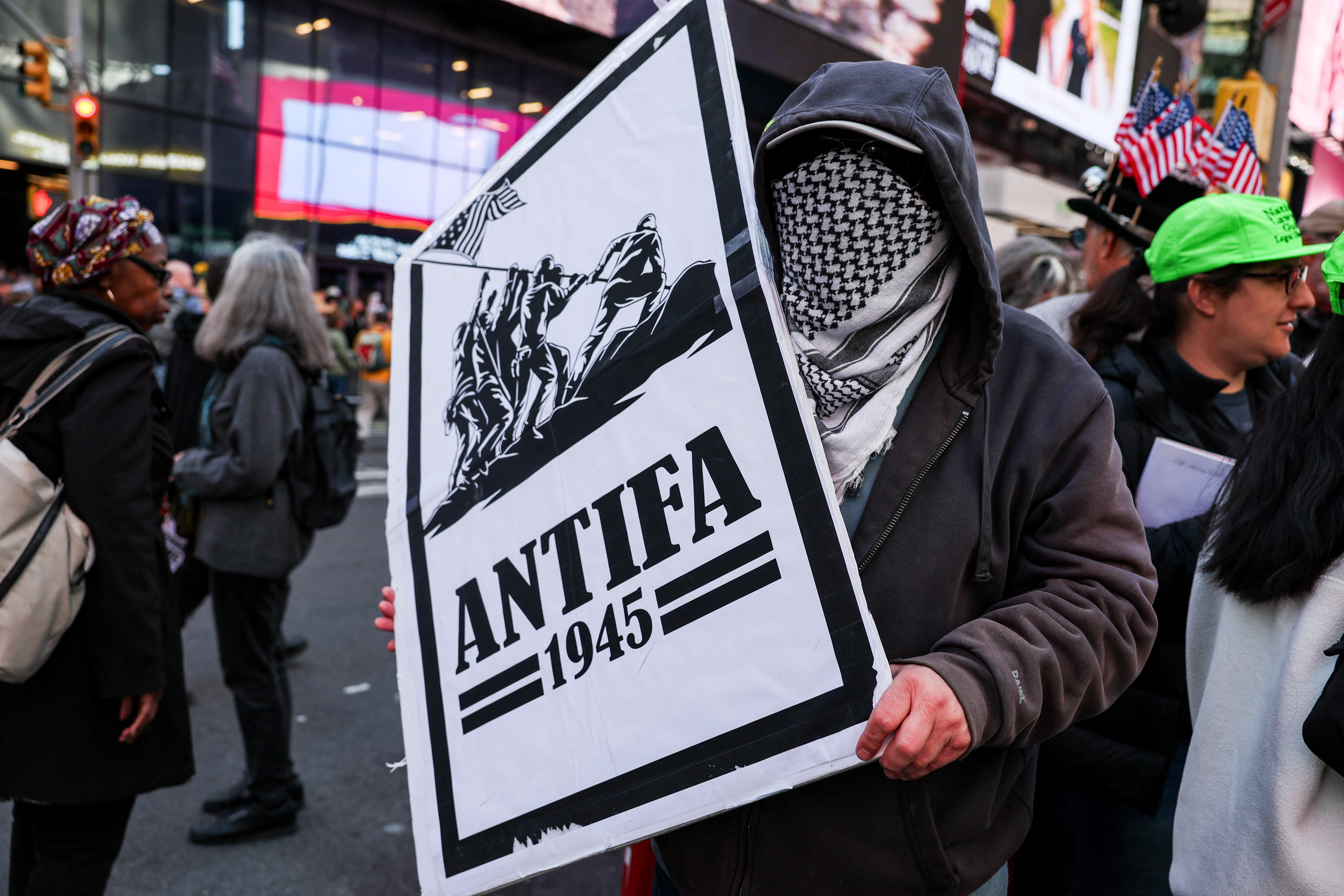 A demonstrator holds an "antifa" placard at a "No Kings" protest in October [Shannon Stapleton/Reuters]