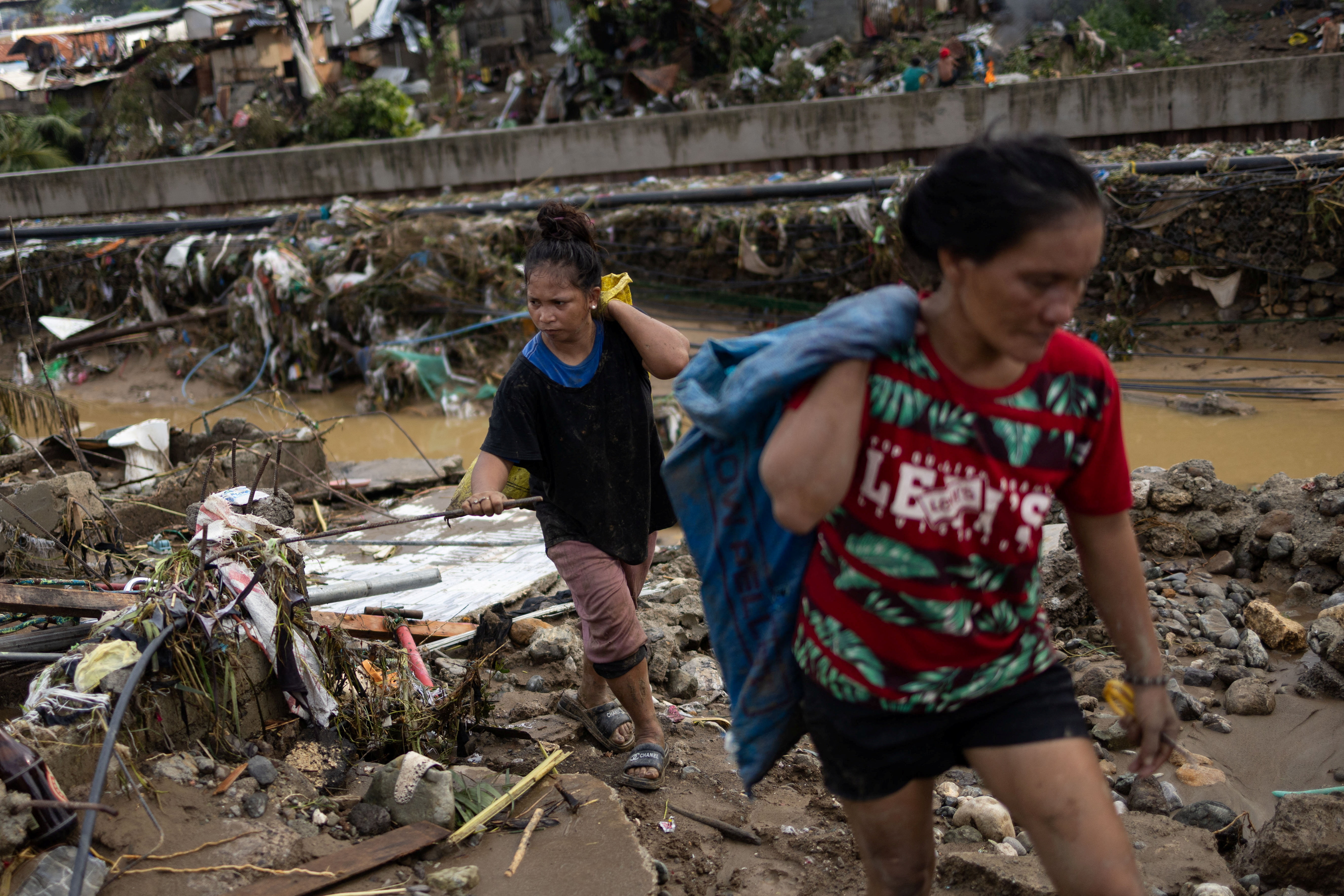 Residents return to the remains of their homes that were swept away in the floods caused by Typhoon Kalmaegi in Talisay, Cebu, Philippines, November 5, 2025. REUTERS/Eloisa Lopez