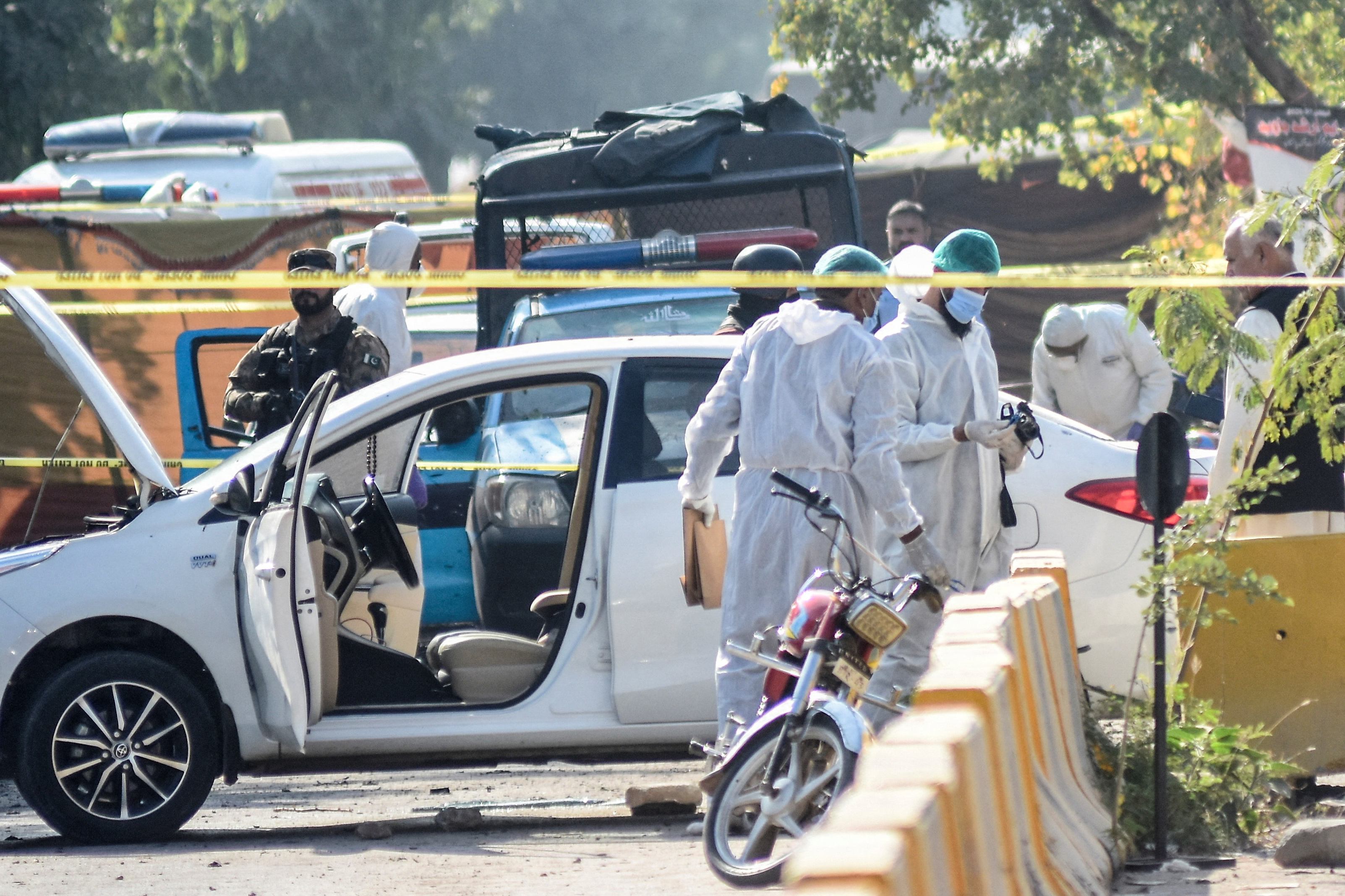 Members of the forensic team work after a blast outside a court building in Islamabad, Pakistan [Waseem Khan/Reuters]