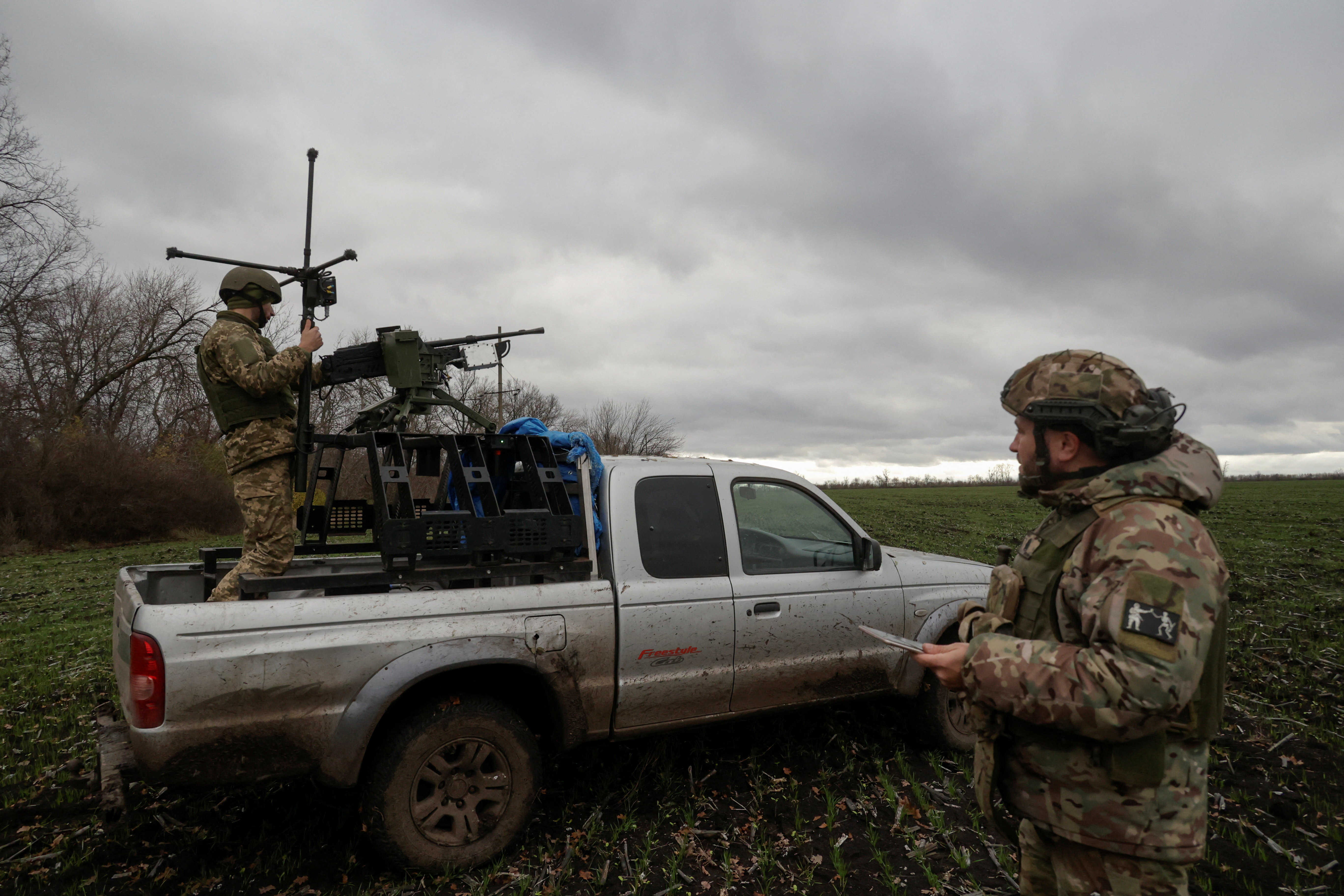 Service members of the 125th Separate Heavy Mechanized Brigade prepare a Kalashnikov tank machine gun, a part of a remote controlled complex for a mobile air defence unit, before its testing near the frontline town of Kupiansk, amid Russia's attack on Ukraine, in Kharkiv region, Ukraine November 13, 2025. REUTERS/Sofiia Gatilova