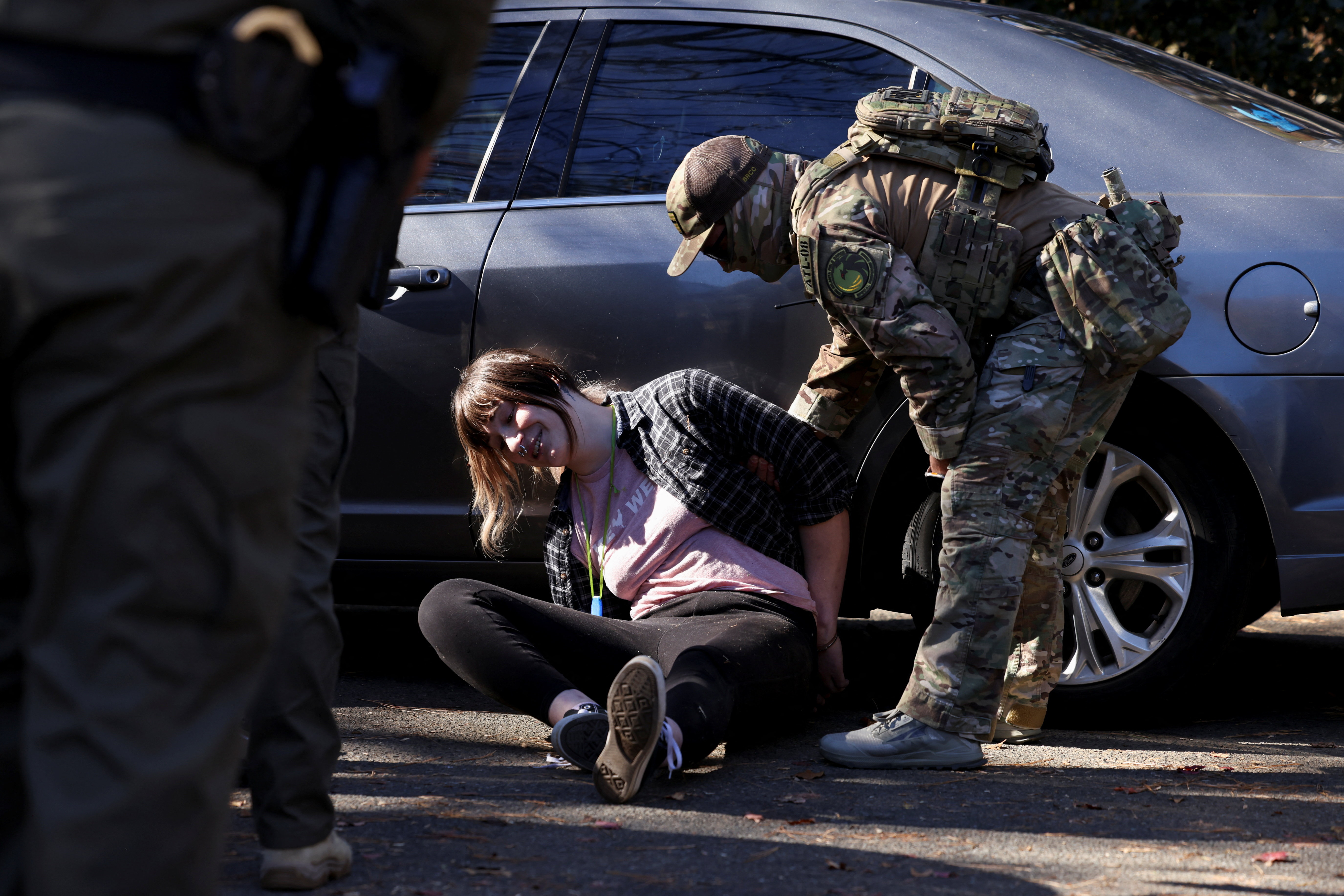 A protester is detained as members of the US Customs and Border Protection conduct raids on the streets of Charlotte, North Carolina