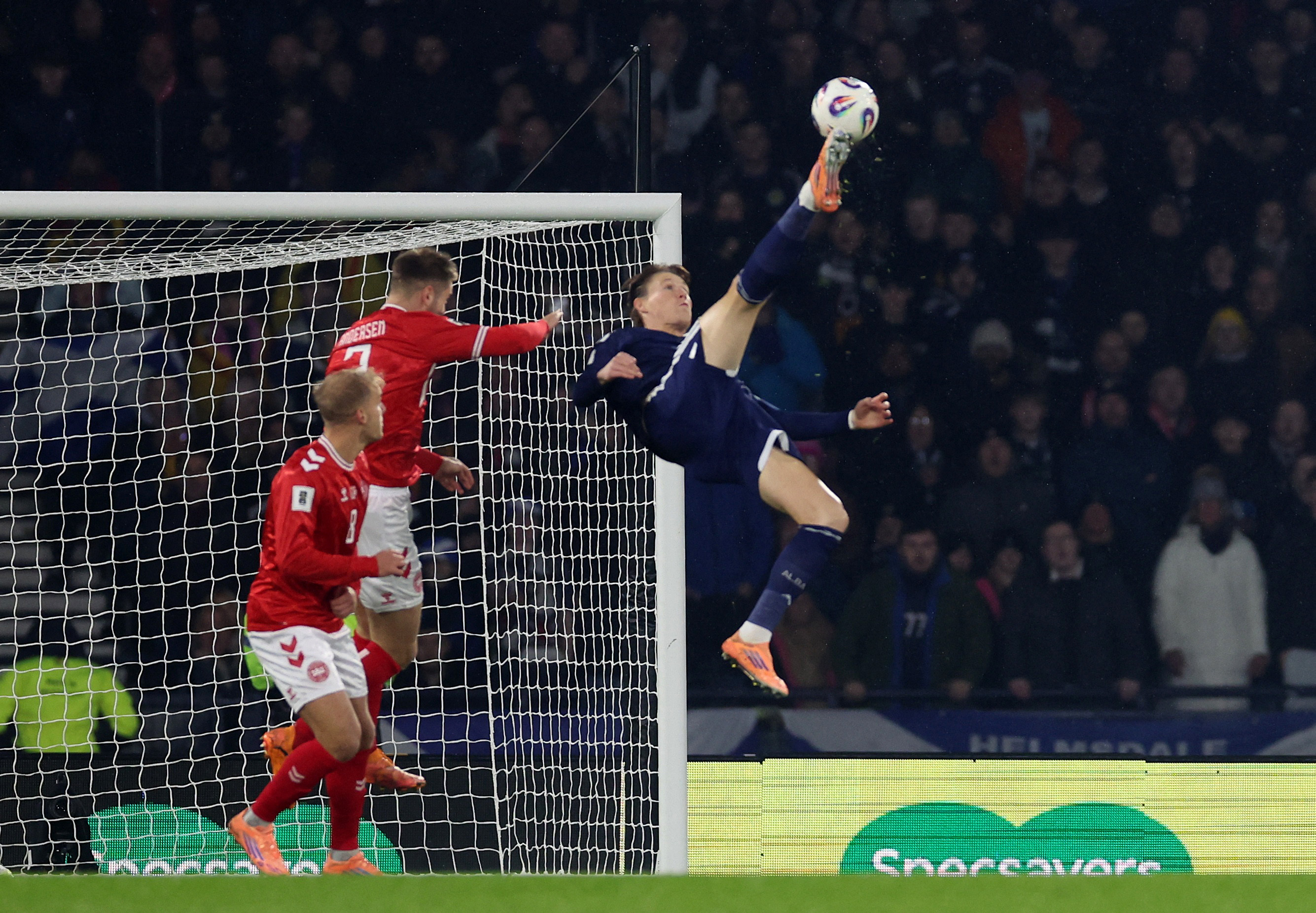 Scott McTominay scores Scotland's first goal with a bicycle kick against the Danes in Glasgow, Scotland