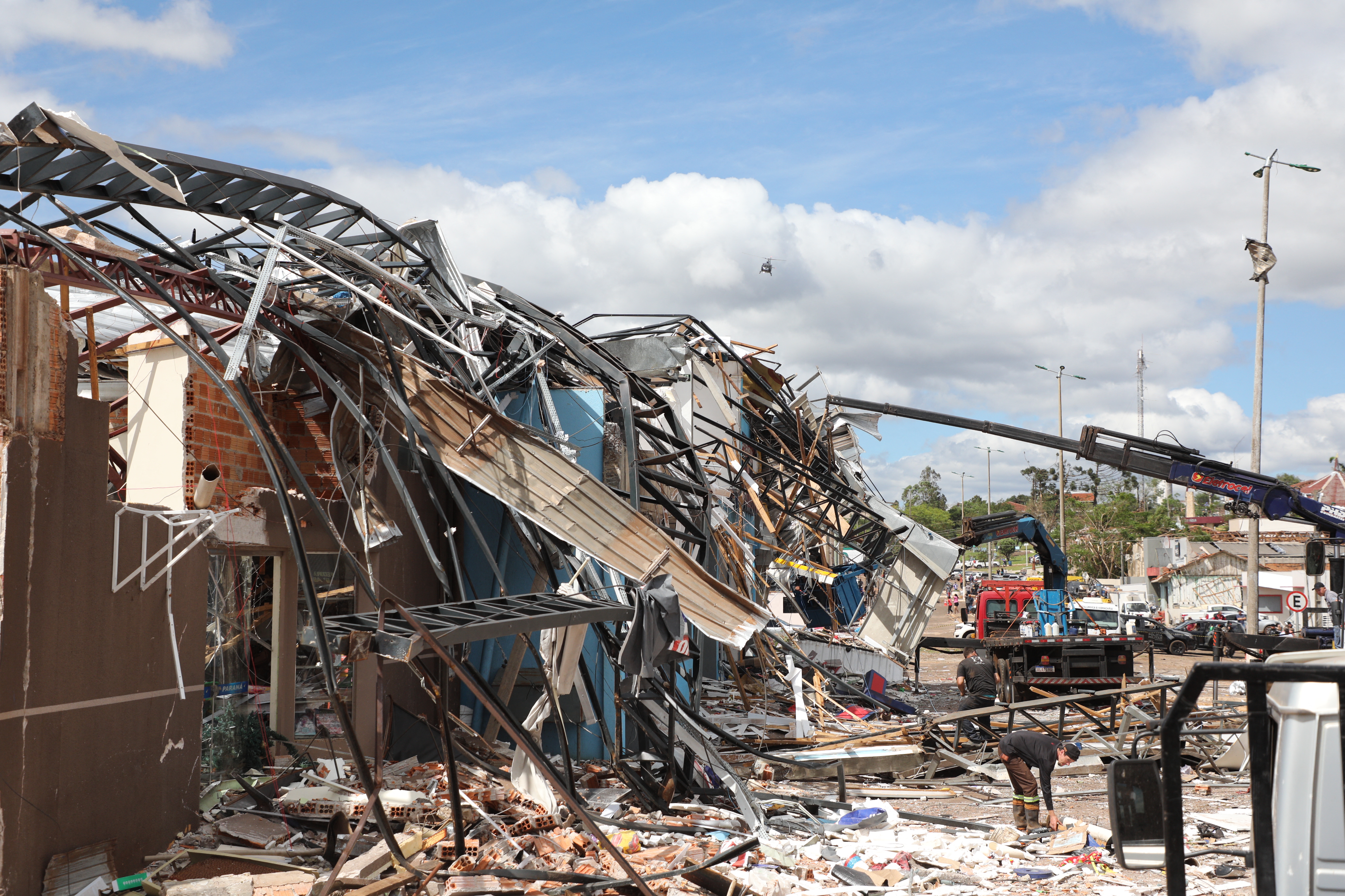 Heavy machinery cleans up the debris caused by the tornado with winds of up to 250 kilometers per hour that hit the city of Rio Bonito do Iguacu, Parana State, Brazil on November 8, 2025. A tornado killed at least six people and injured around 750 as it destroyed most of a town in southern Brazil, authorities said Saturday. The twister on Friday evening flipped cars like toys and wrecked buildings in Rio Bonito do Iguacu, a town of 14,000 people in Parana state, officials said. (Photo by Daniel Castellano / AFP)