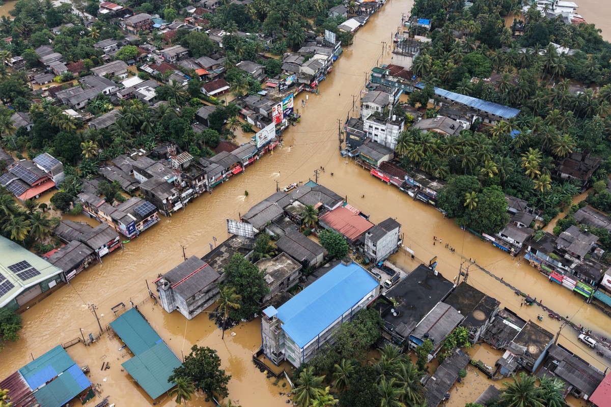 An aerial view shows houses partially submerged in floodwaters after heavy rainfall in Kaduwela on the outskirts of Colombo on November 29, 2025.Sri Lanka declared a state of emergency on November 29, and appealed for international assistance as the death toll from heavy rains and floods triggered by Cyclone Ditwah rose to 132, with another 176 reported missing.