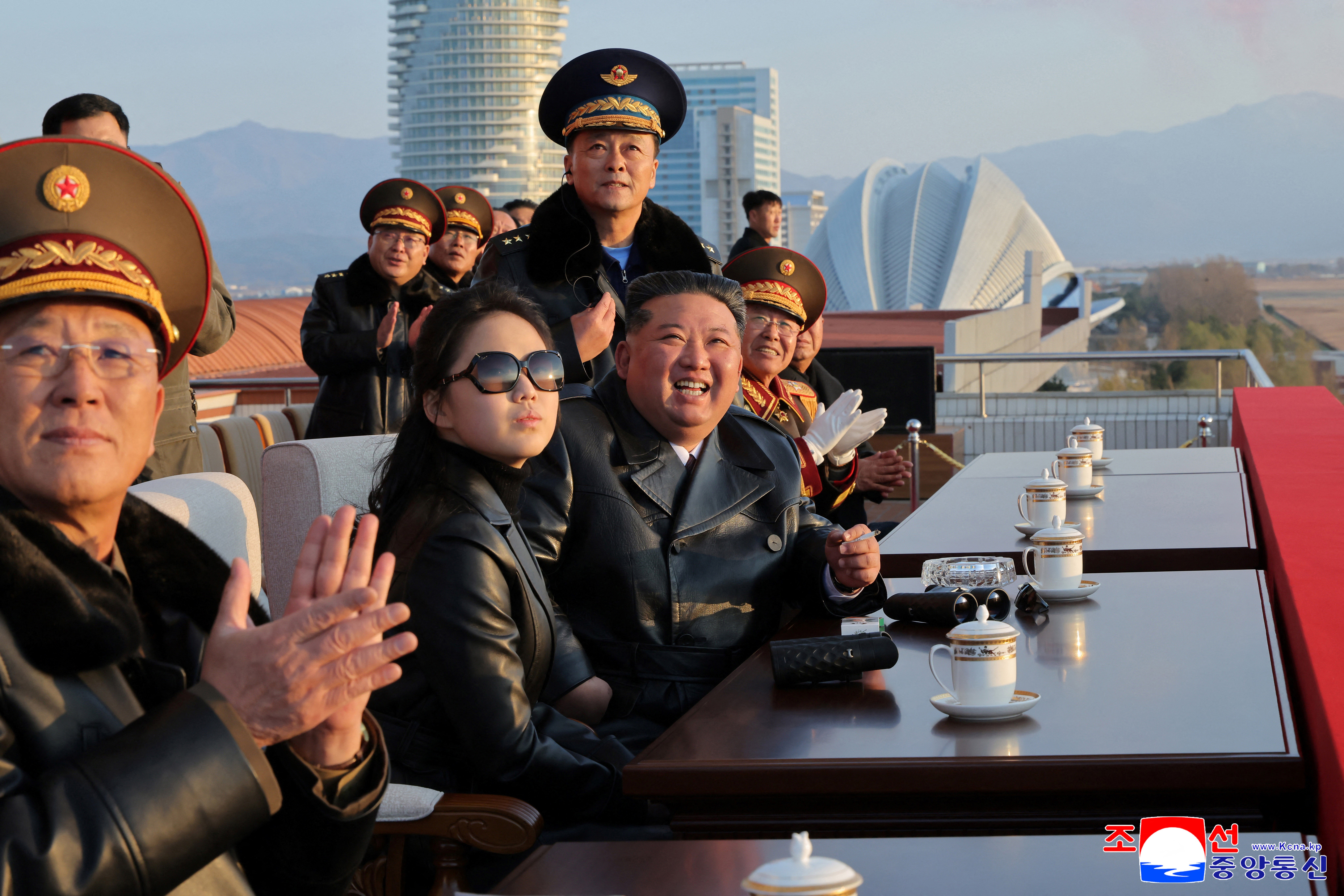 North Korean leader Kim Jong Un (3rd L) and his daughter Ju Ae (2nd L) watching a demonstration flight commemorating the 80th anniversary of the founding of the Korean People's Army Air Force at Kalma Airfield in Wonsan, Gangwon Province.