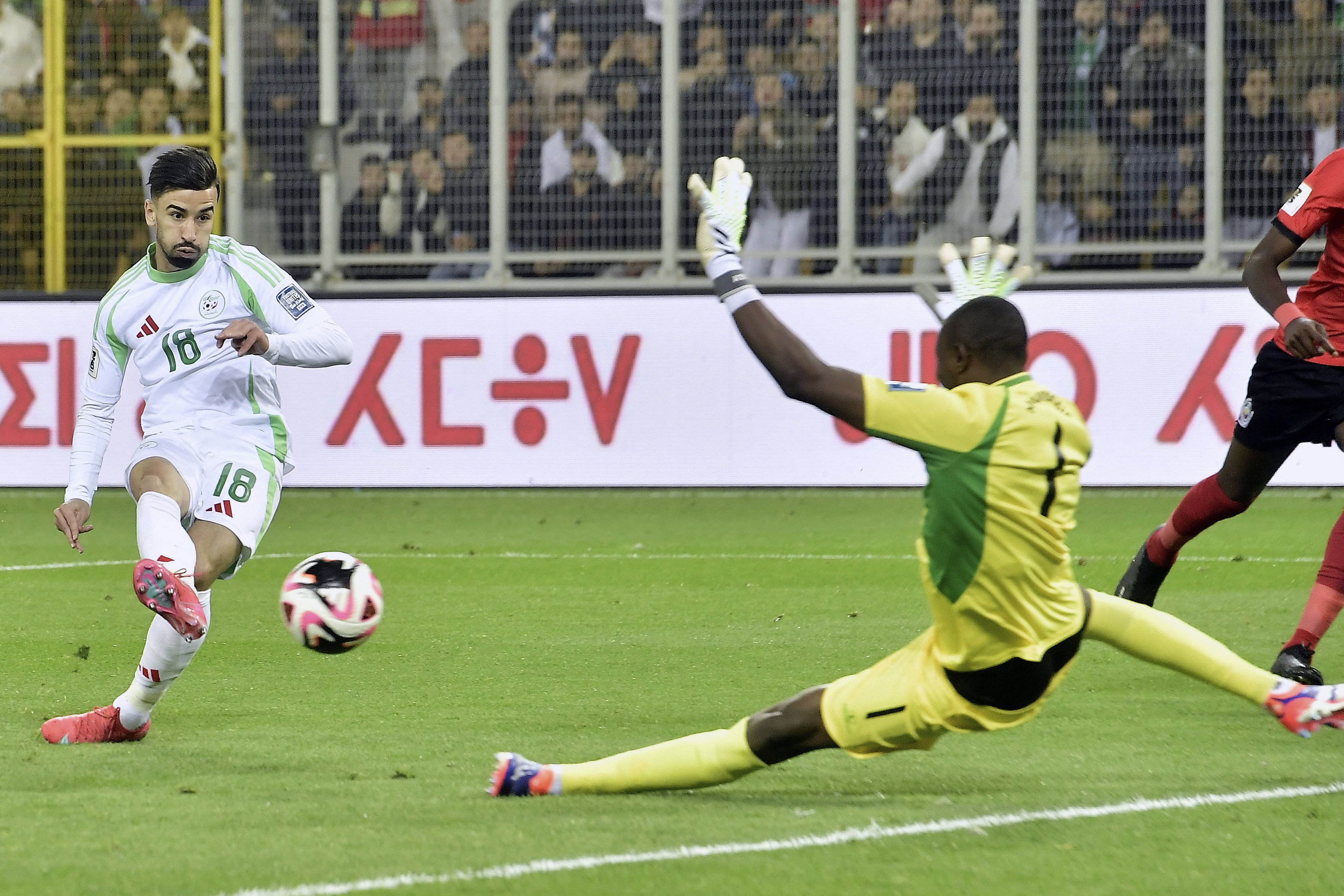 Algeria's Mohamed Amoura scores as Mozambique goalkeeper Ernan Siluane misses the ball during the World Cup 2026 group G qualifying soccer match between Algeria and Mozambique at the Hocine-Ait-Ahmed stadium in Boukhalfa, near Tizi Ouzou, eastern Algeria, Tuesday March 25, 2025. (AP Photo/Fateh Guidoum)