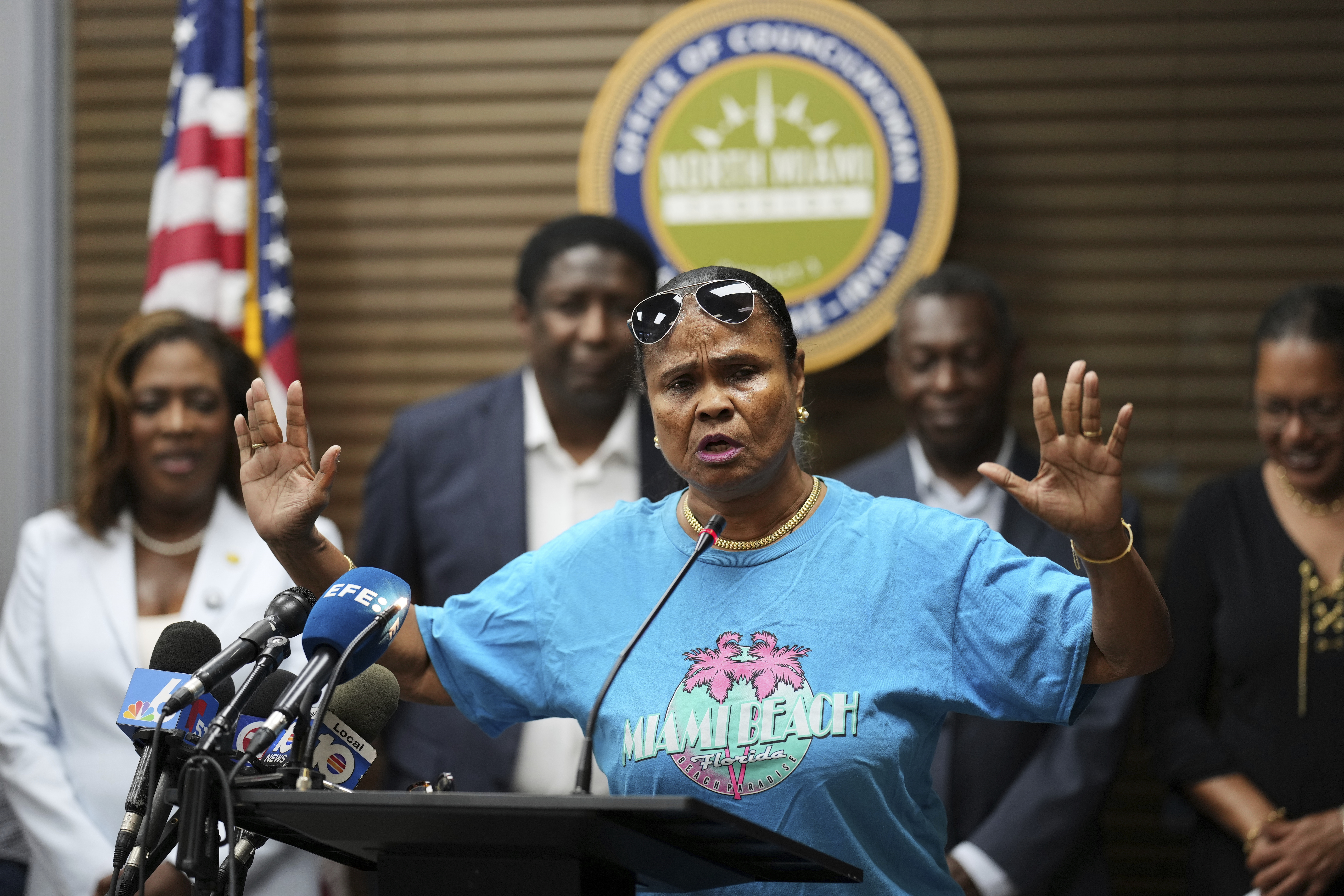 Farah Juste speaks at a podium.