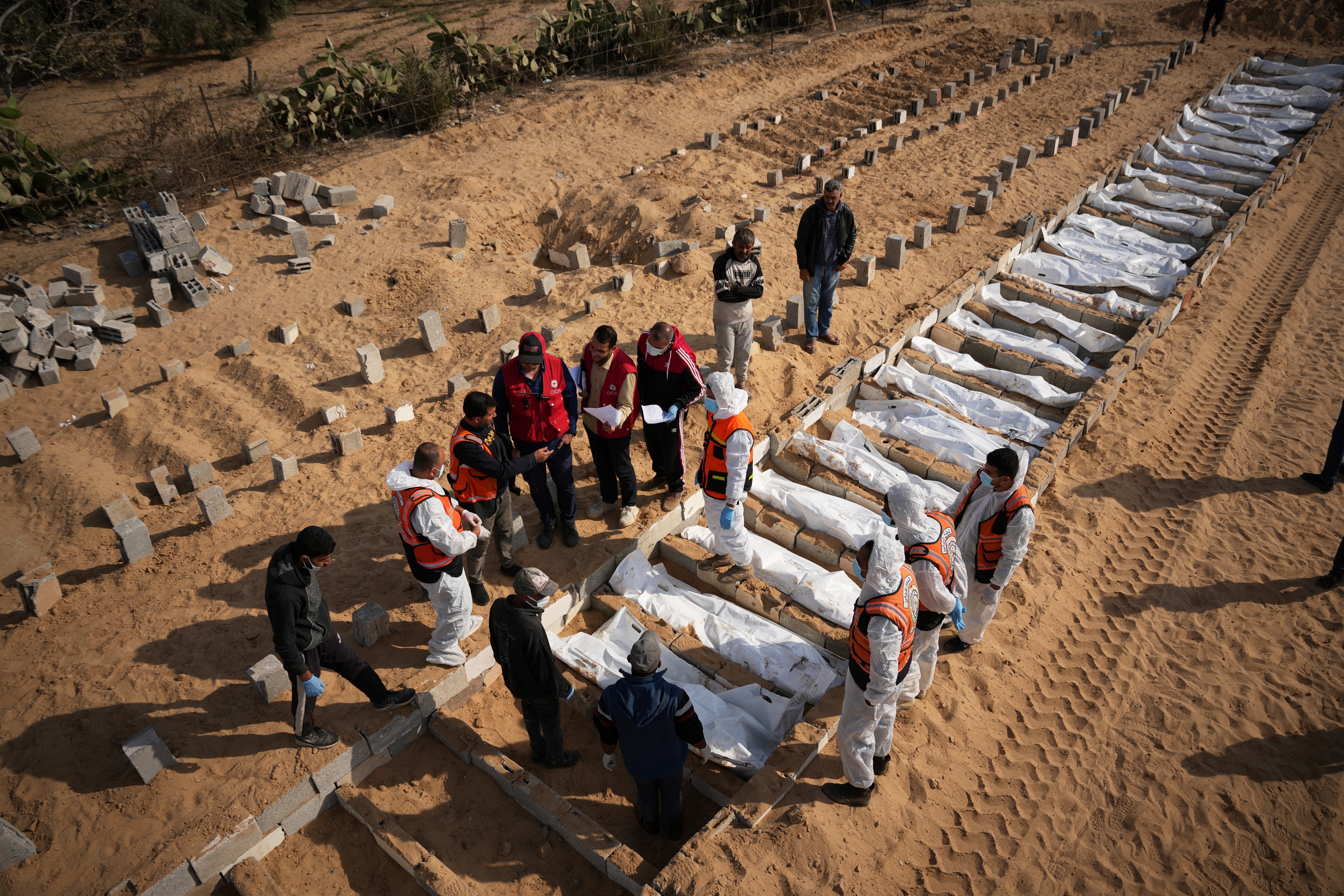 Bodies of unidentified Palestinians returned from Israel as part of the ceasefire deal are buried in Deir al-Balah, Gaza Strip