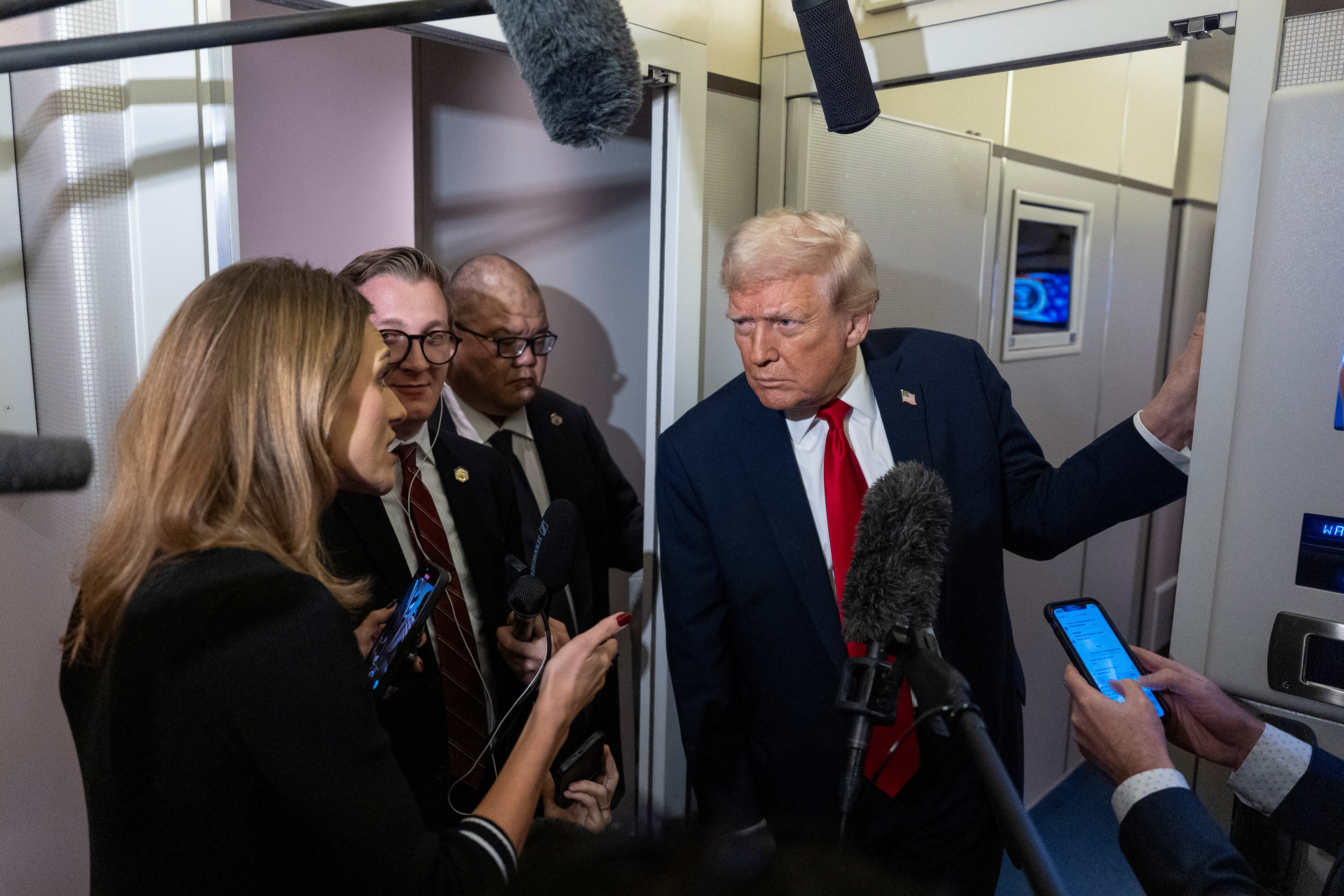 Trump speaks to reporters on Air Force One