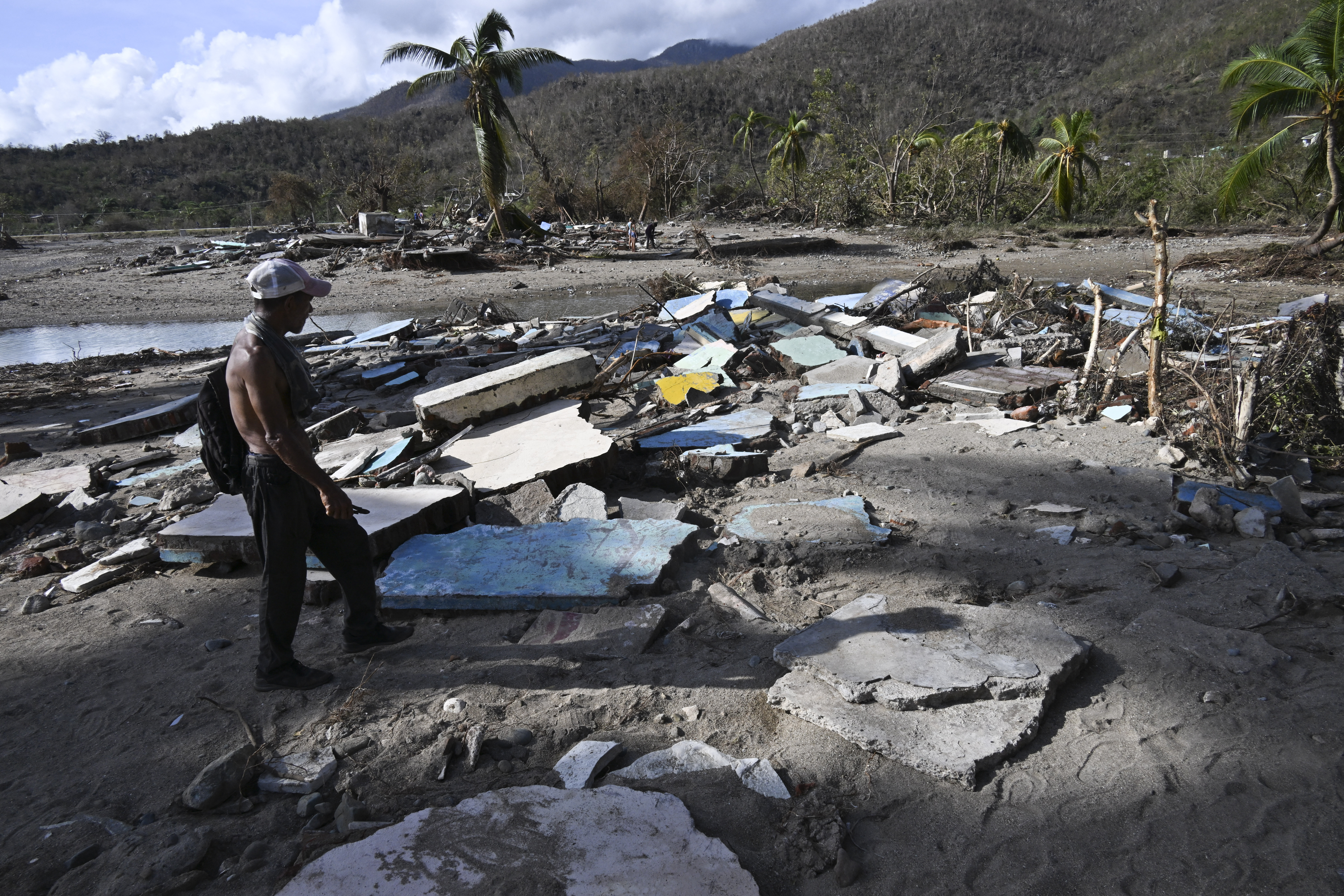 A man walks amid debris of a damaged house after the passage of Hurricane Melissa in Boca de Dos Rios village, Santiago de Cuba province, Cuba on October 30, 2025.