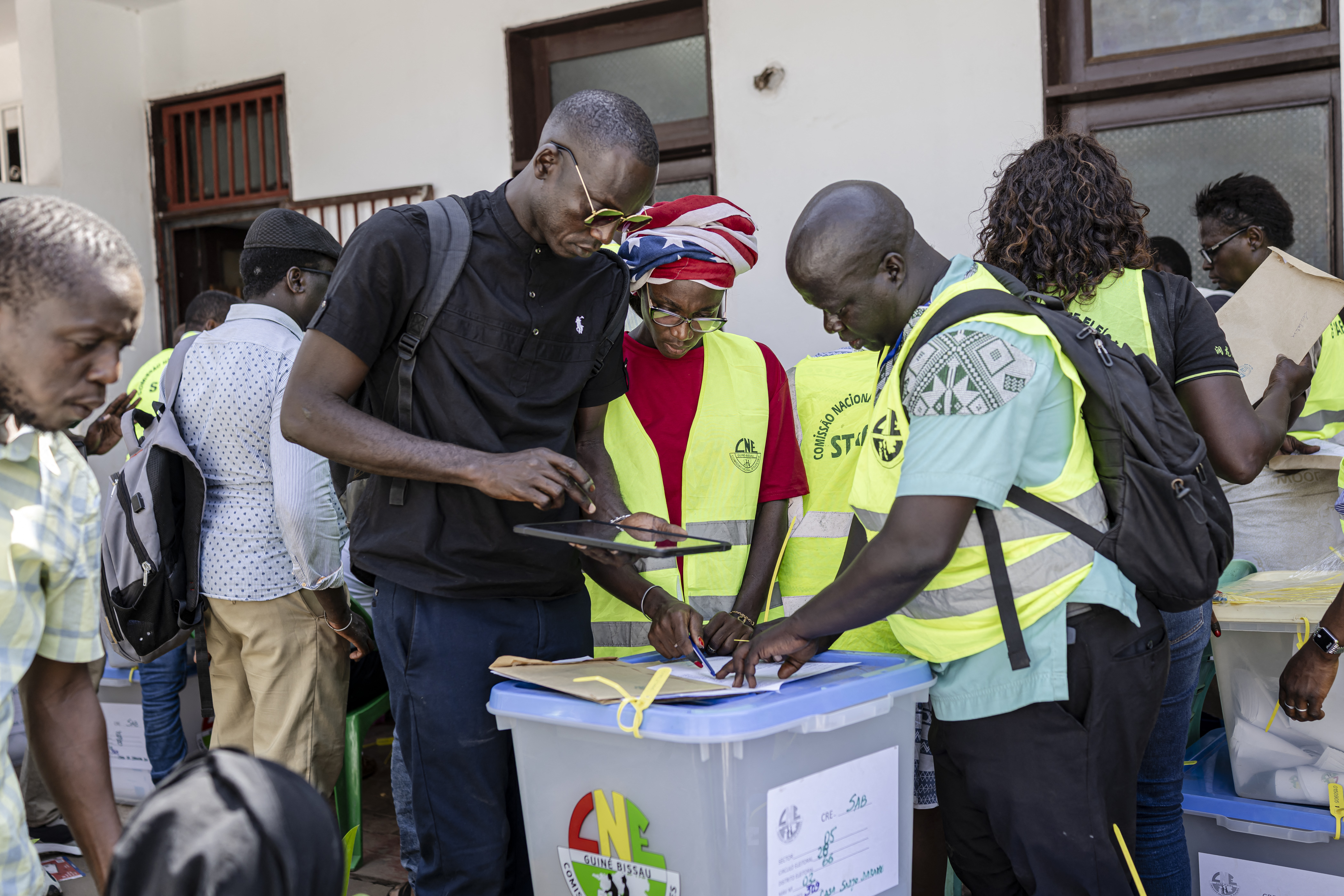 Officials from the National Electoral Commission (CNE) collect documents accompanying ballot boxes received from different polling stations at their headquarters in Bissau, on November 24, 2025, the day after Guinea-Bissau’s presidential and legislative elections. (Photo by PATRICK MEINHARDT / AFP)