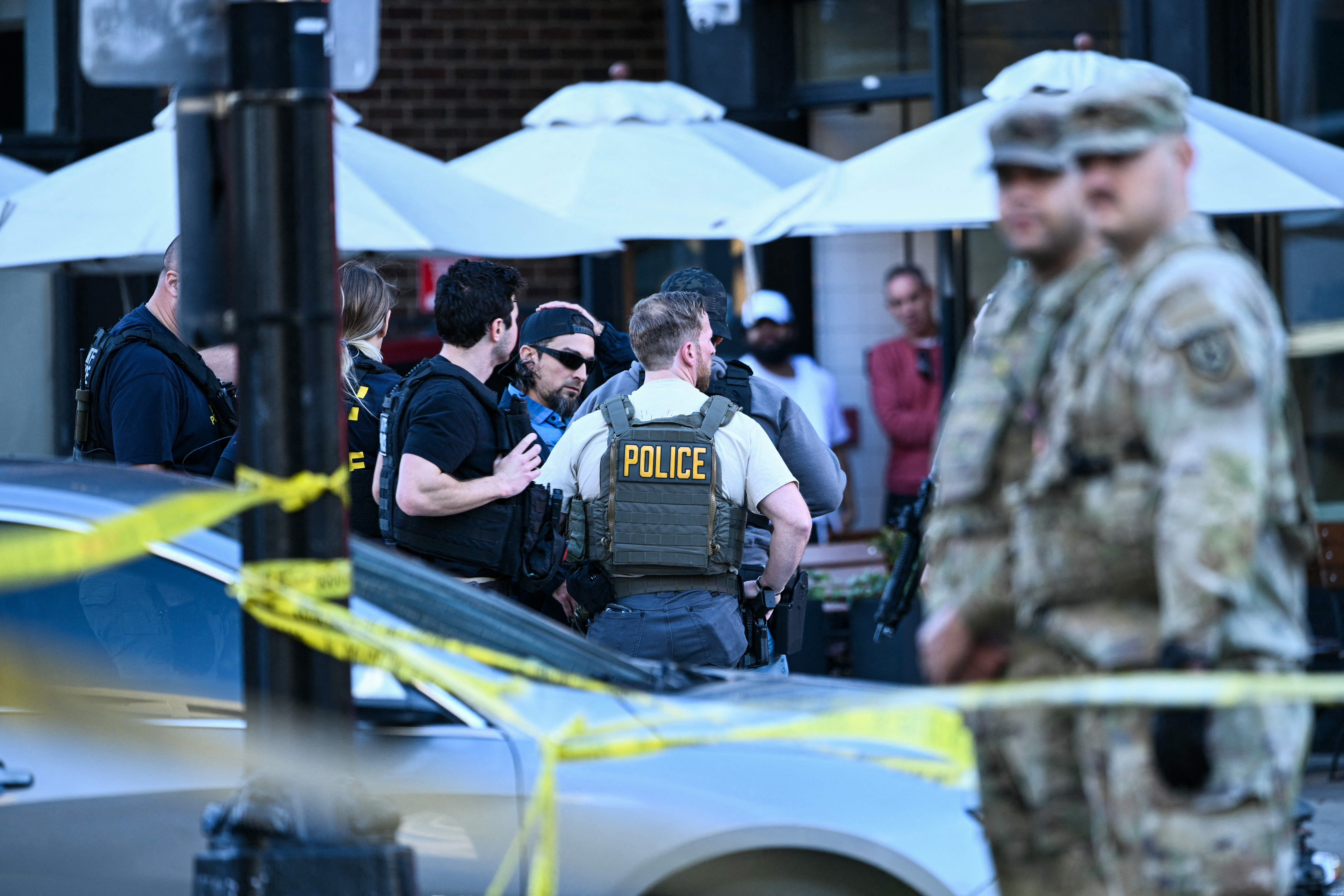 Law-enforcement officers secure the area after a shooting in downtown Washington, on November 26, 2025.