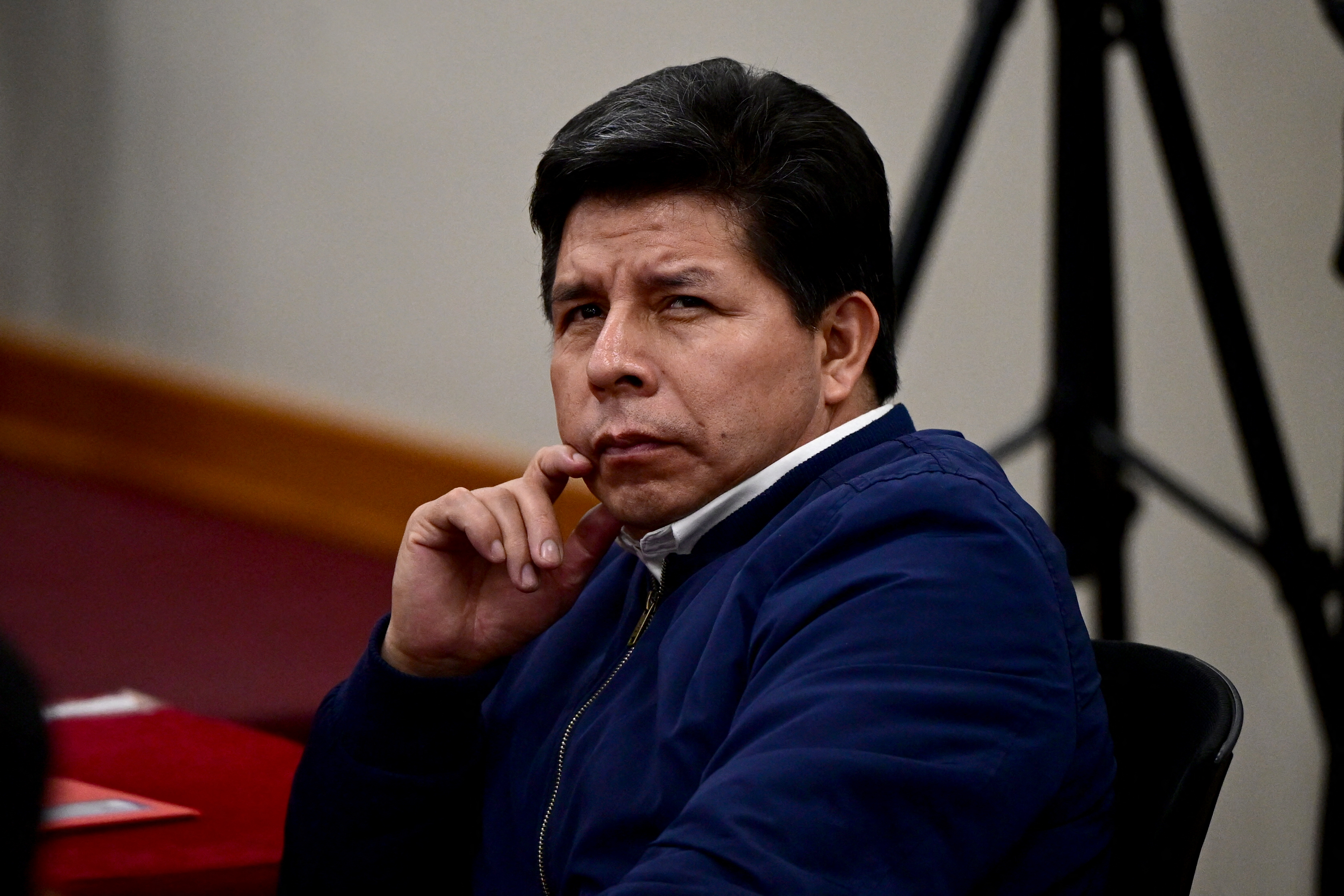 Peru's former President (2021–2022) Pedro Castillo gestures in the courtroom of the National Police Special Operations Directorate (DINOES) as the verdict is issued in his trial in Lima on November 27, 2025.