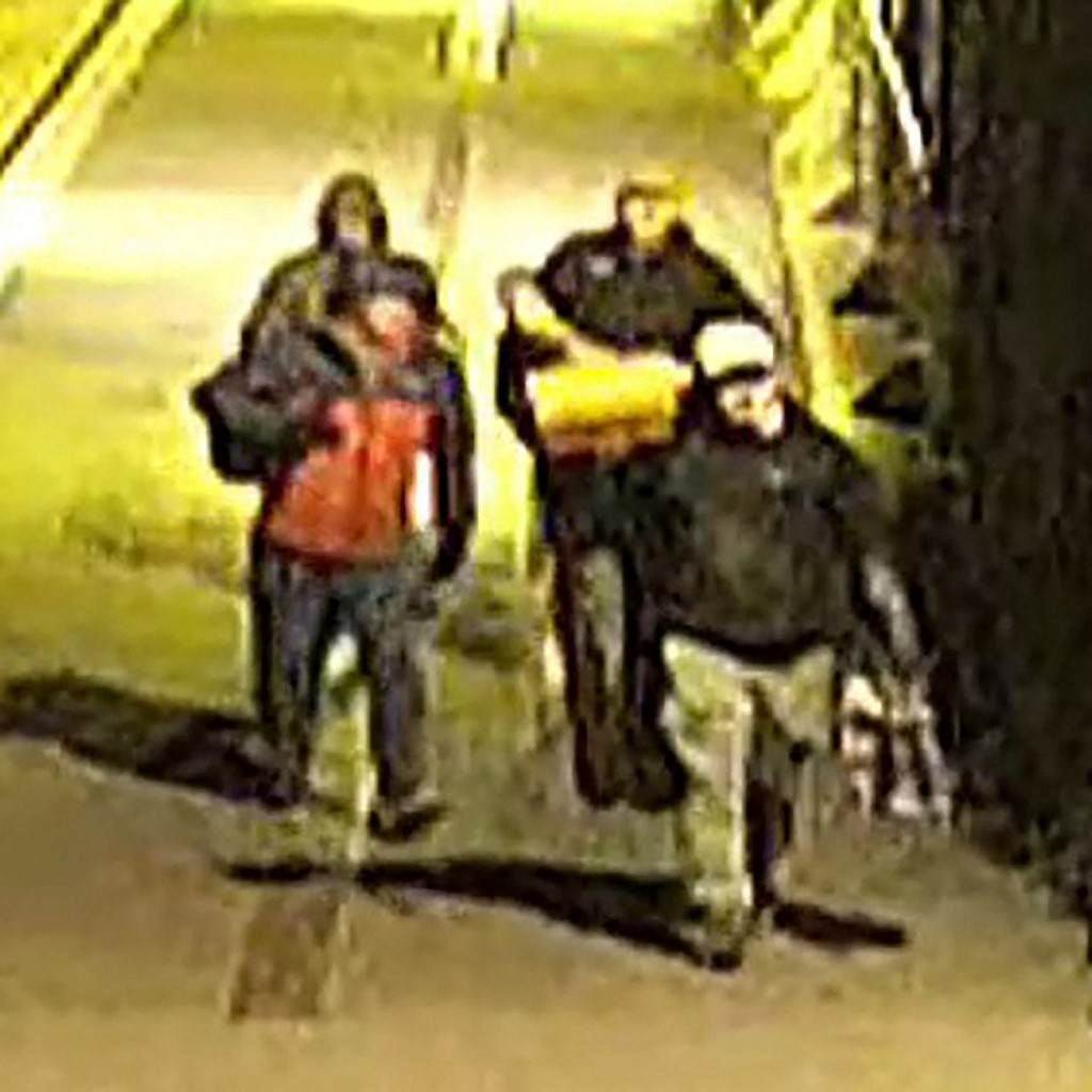 This handout image of CCTV footage released by Avon and Somerset Police on December 11, 2025 shows men carrying bags in the early hours of September 25 in the city of Bristol. [Avon and Somerset Police/AFP]