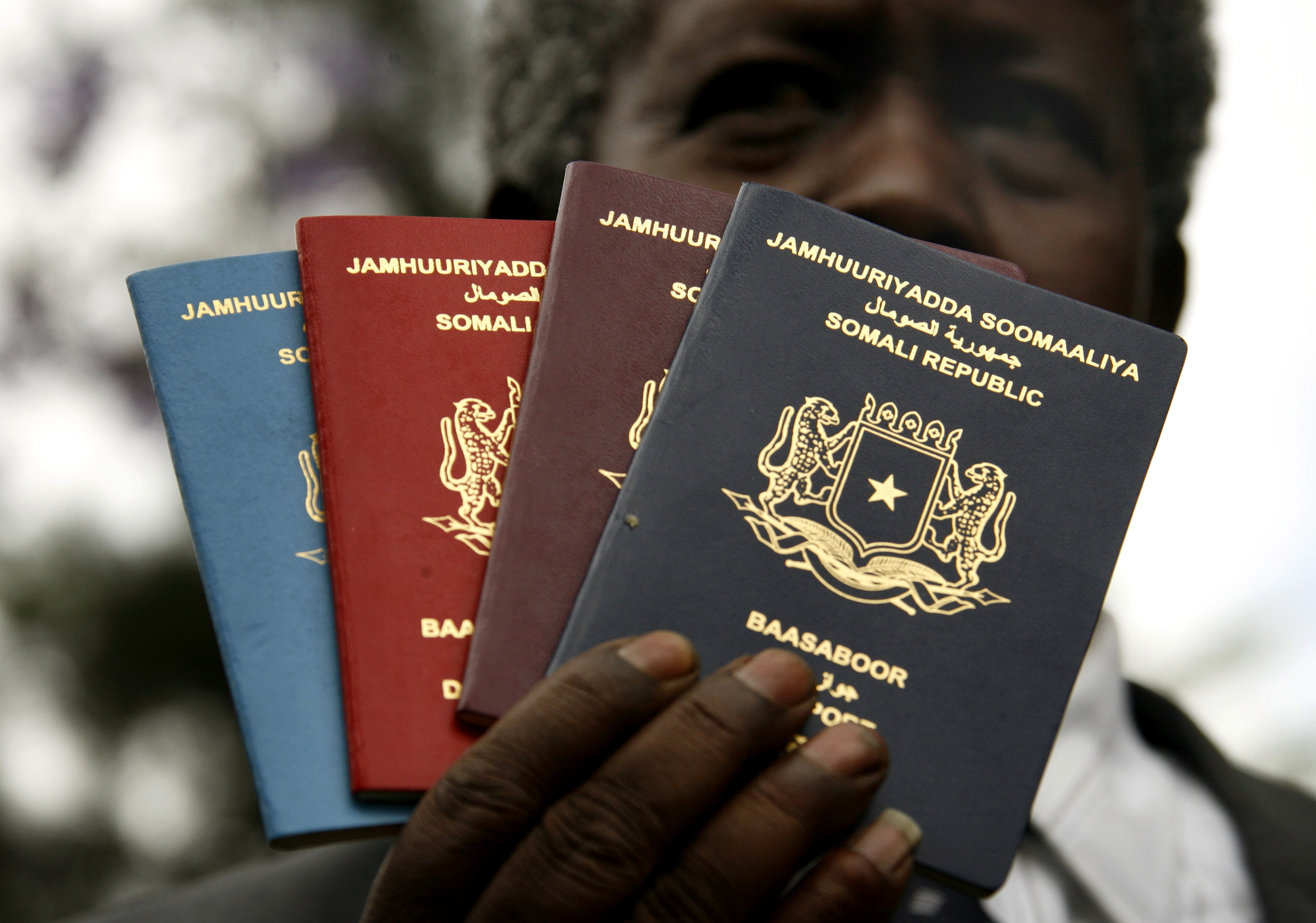 A Somali immigration official holds up new passports