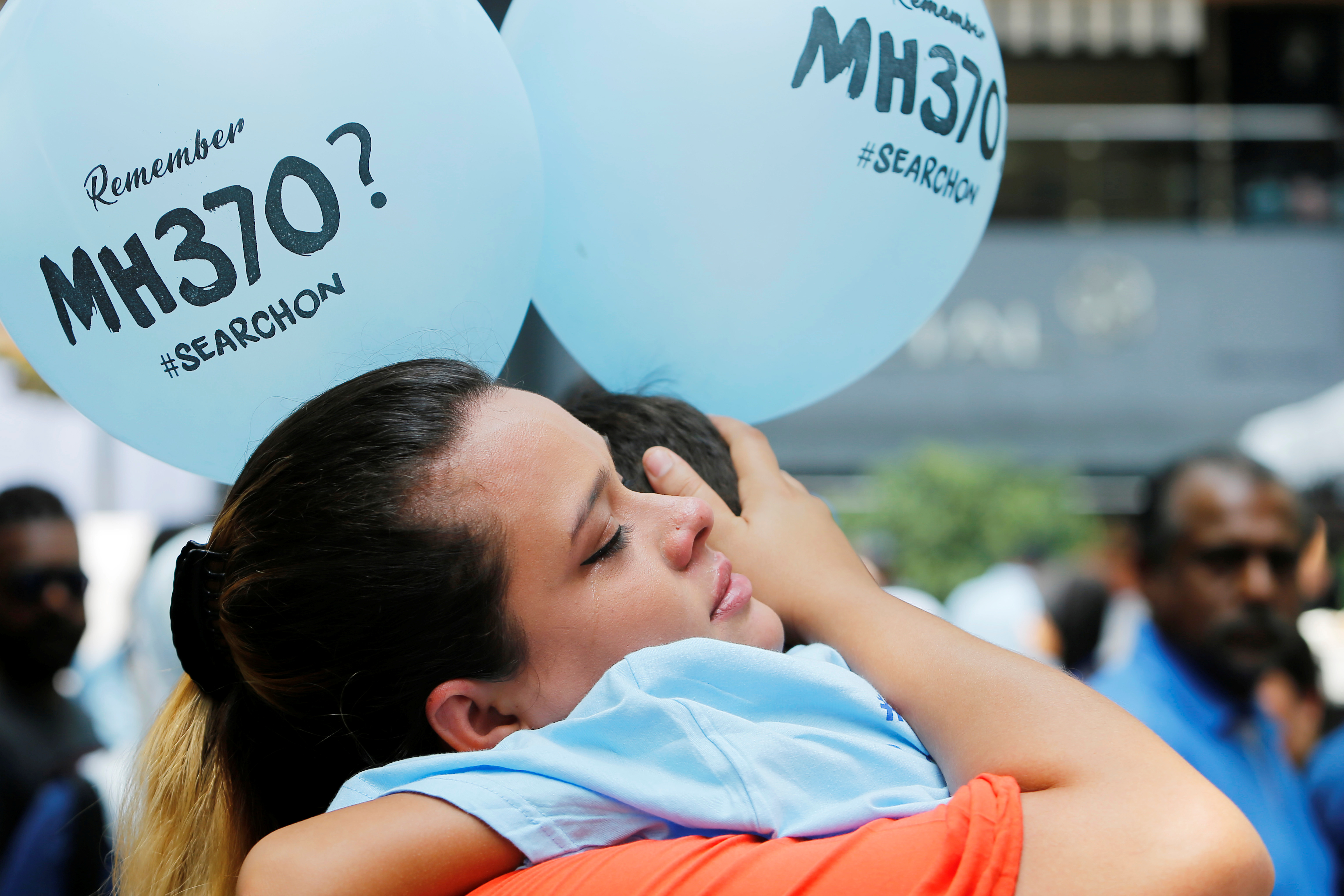 Michelle Gomes, daughter of Patrick Gomes who was the in-flight supervisor onboard the missing Malaysia Airlines flight MH370, comforts her son Rafael Gomes during its fifth annual remembrance event in Kuala Lumpur, Malaysia March 3, 2019. REUTERS/Lai Seng Sin