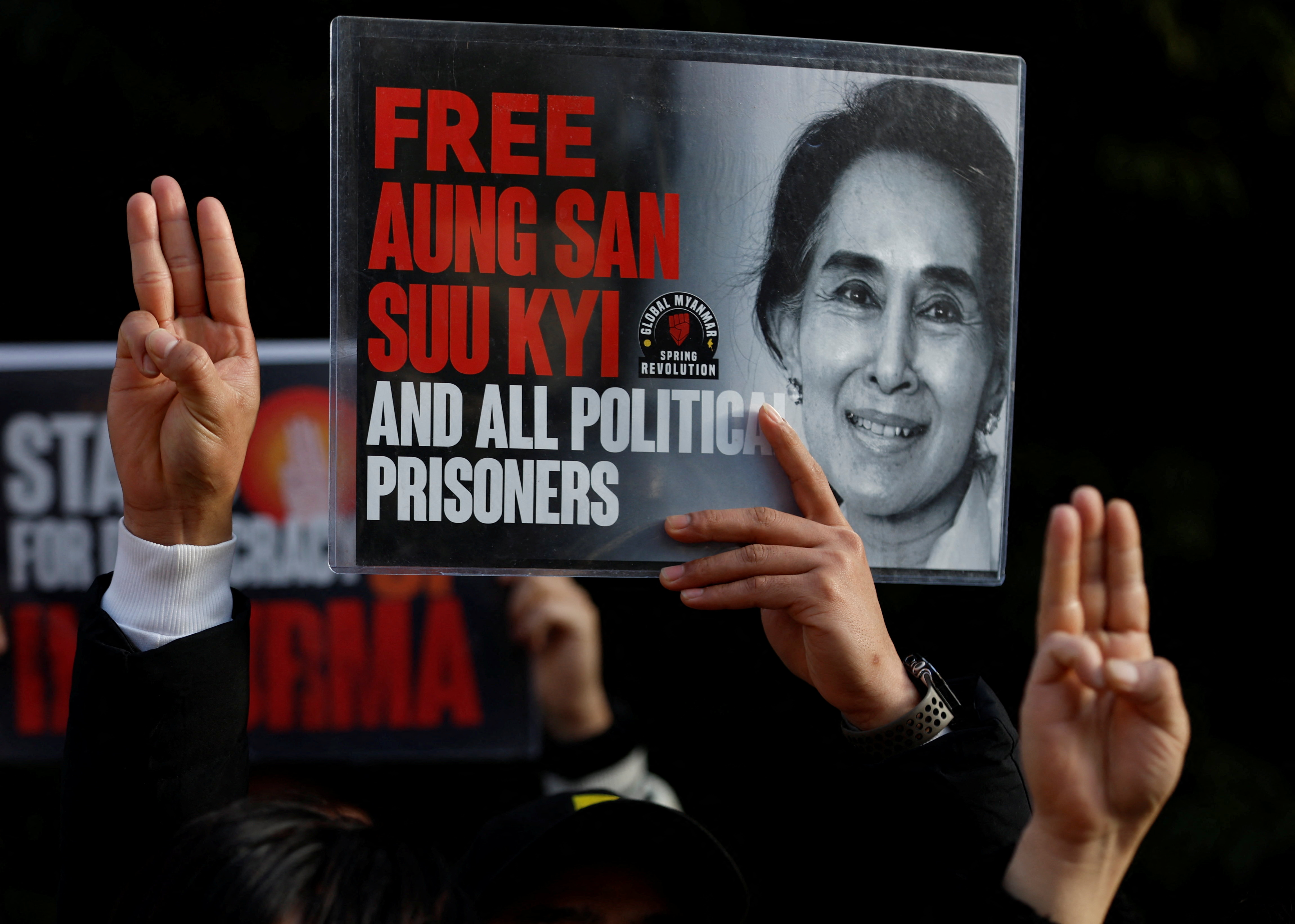 Protesters show off the portrait of Aung San Suu Kyi.
