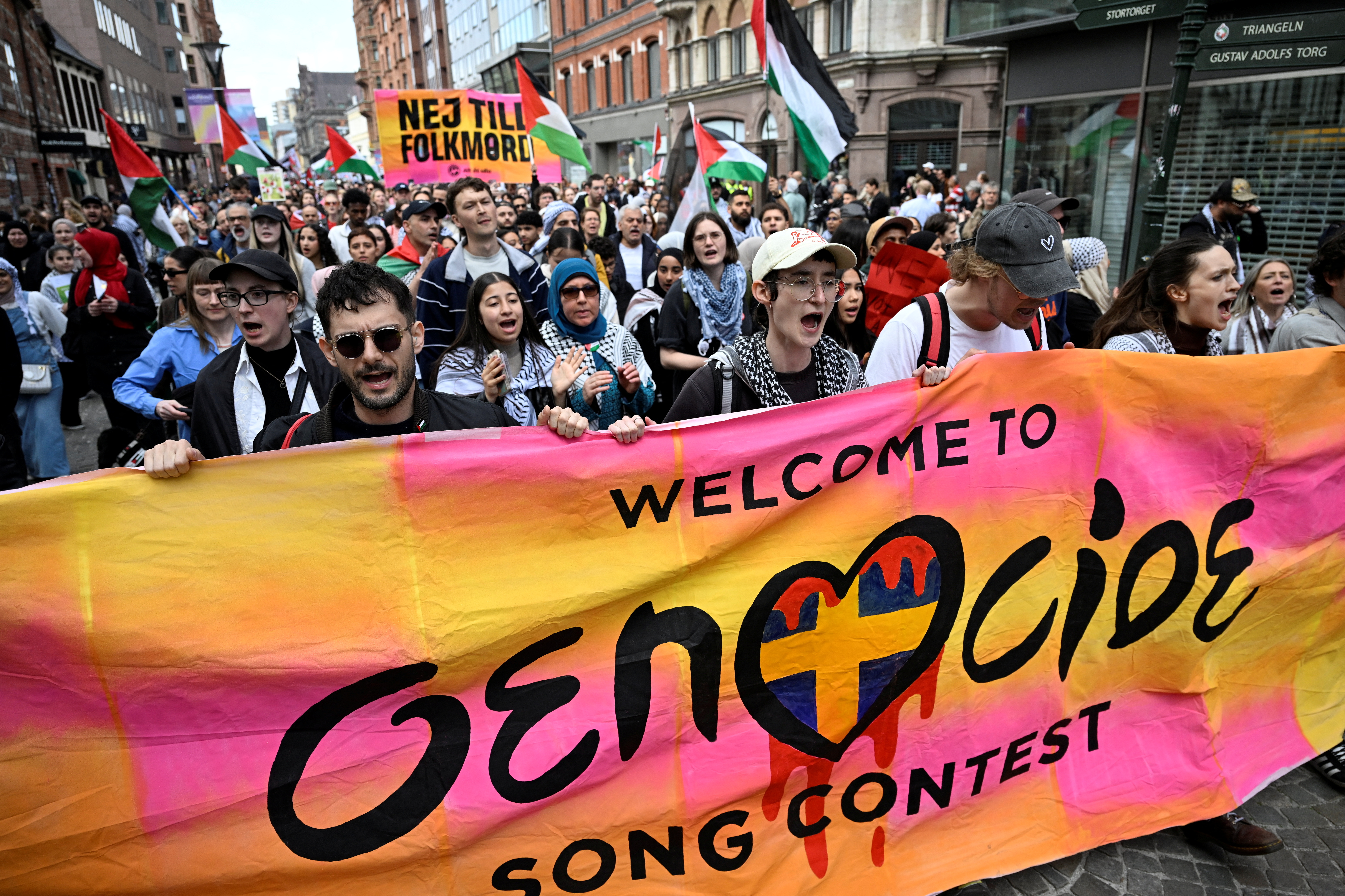 Protesters hold a banner and Palestinian flags during the "Stop Israel" demonstration, against Israel's participation in the Eurovision Song Contest due to its ongoing offensive in Gaza against Hamas, in Malmo, Sweden