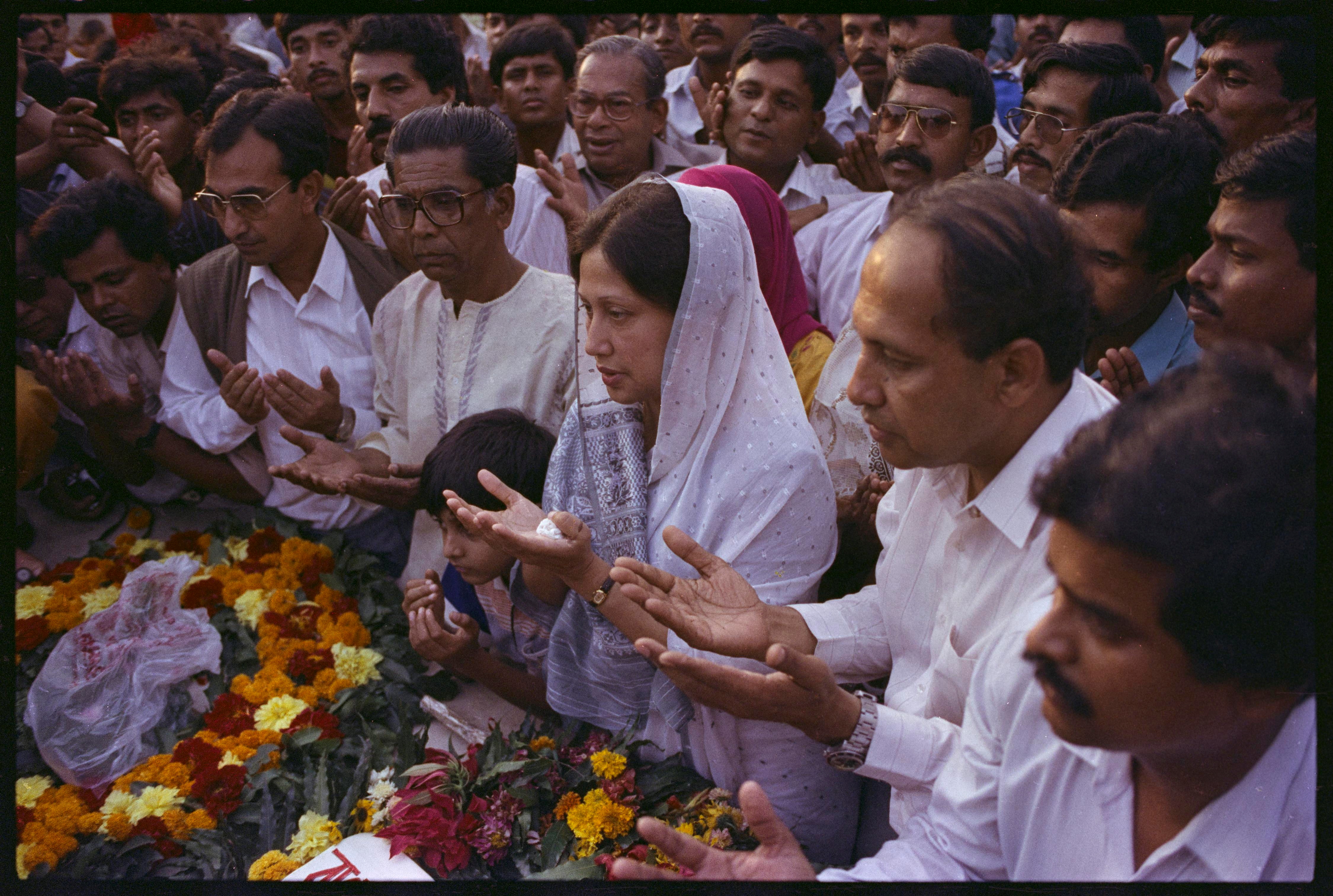 Bangladesh Nationalist Party chief Begum Khaleda Zia raises her hands in silent prayer ,at the memorial of her late husband General Ziaur Rahman, who was killed in 1981. Her party has taken the lead in the country's first free elections in over 20 years. February 28, 1991 REUTERS/Carl Ho 91114032 BANGLADESH CANDIDATE ELECTION GESTURE MEMORIAL PRAYING SPOUSE WOMAN; Rahman, Ziaur Zia, Begum Khaled Begum Khaleda Zia Ziaur Rahman DISCLAIMER: The image is presented in its original, uncropped, and untoned state. Due to the age and historical nature of the image, we recommend verifying all associated metadata, which was transferred from the index stored by the Bettmann Archives, and may be truncated.