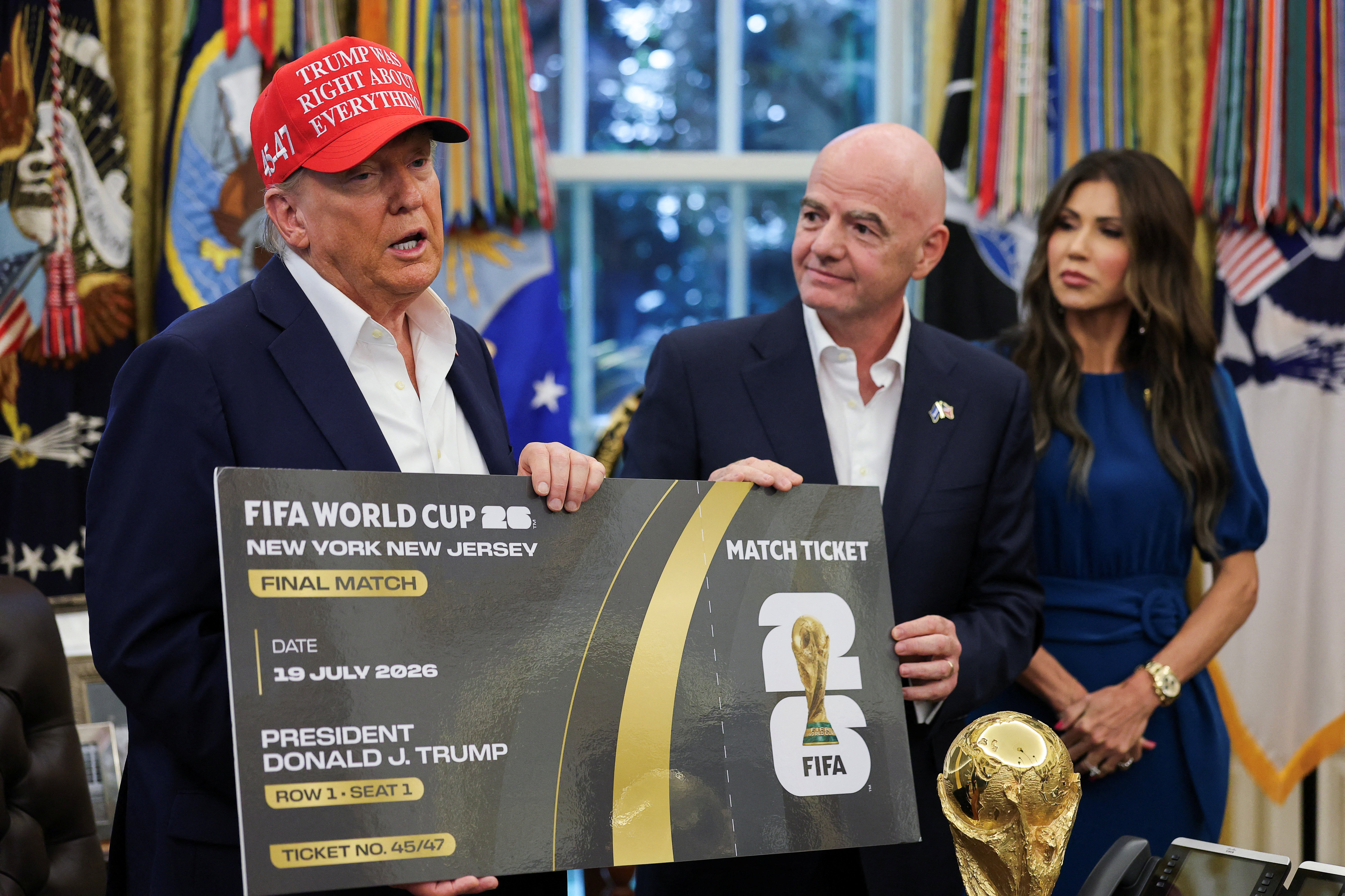 U.S. President Donald Trump and FIFA president Gianni Infantino hold a 2026 FIFA World Cup final match ticket that was presented to President Trump, as the President makes an announcement on the 2026 FIFA World Cup