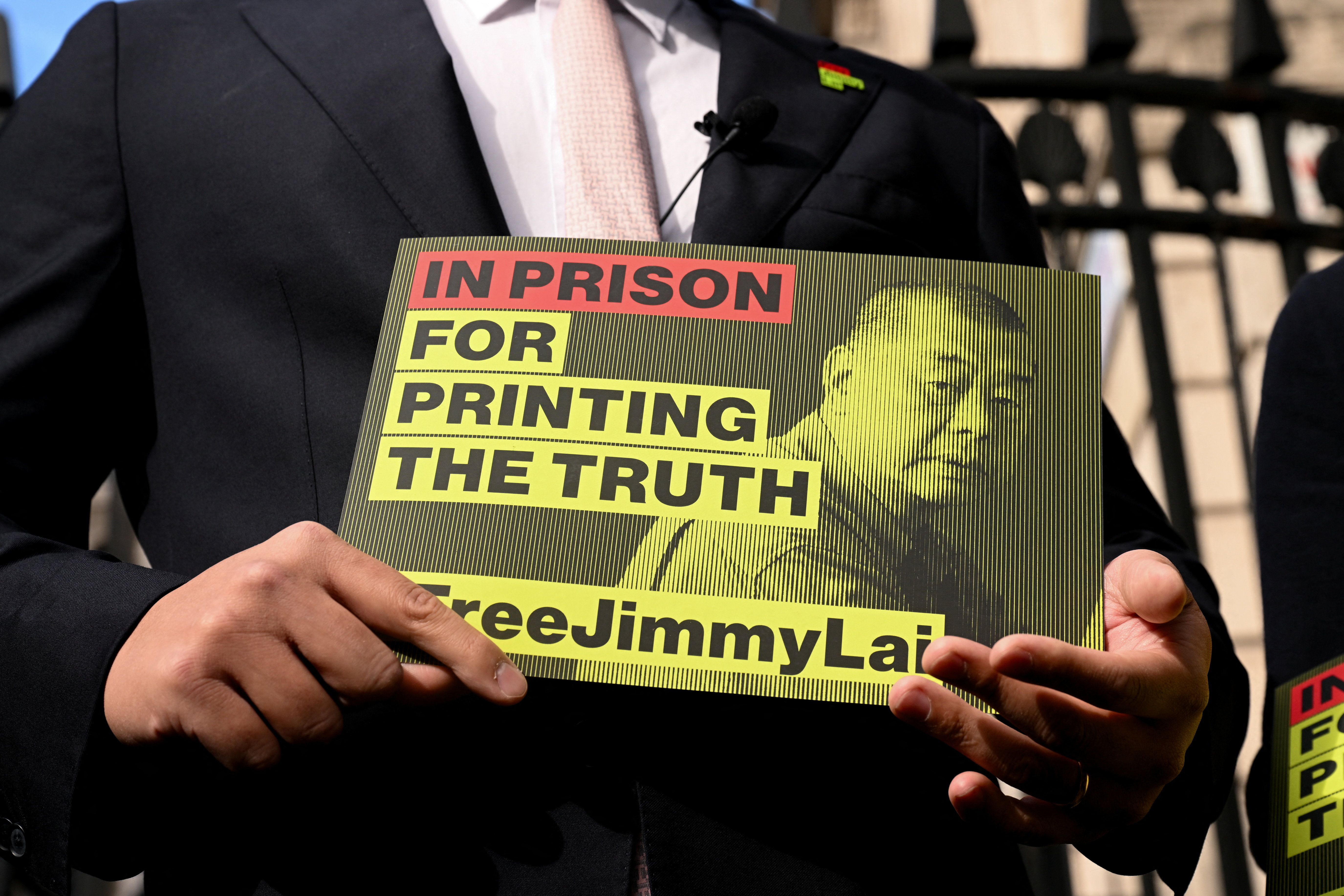 Sebastien Lai, son of jailed media tycoon Jimmy Lai, holds a sign in support of his father.