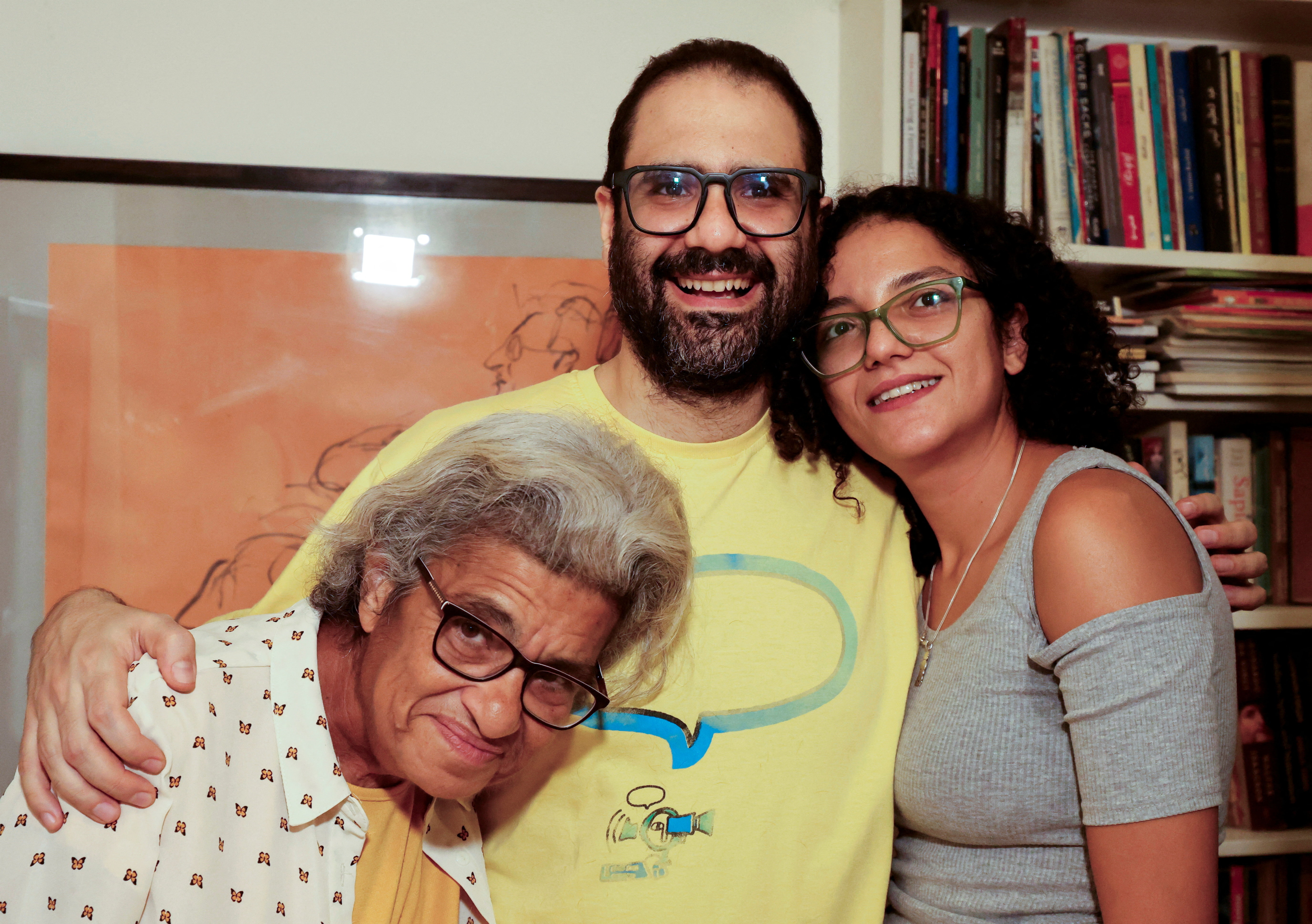 Prominent British-Egyptian activist Alaa Abd el-Fattah, who was released from prison after Egyptian President Abdel Fattah al-Sisi issued a presidential pardon for him, stands next to his mother, Laila Soueif, and sister, Sanaa, at home in Giza, Egypt, September 23, 2025. REUTERS/Mohamed Abd El Ghany