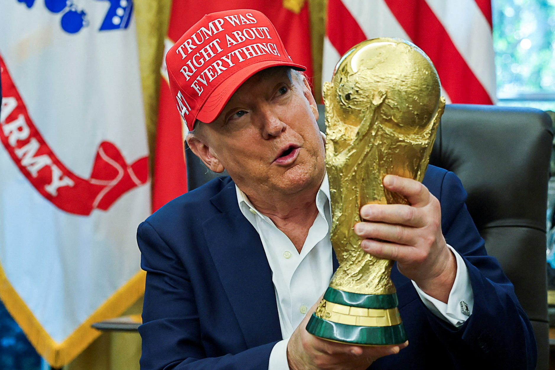 Donald Trump holds World Cup trophy