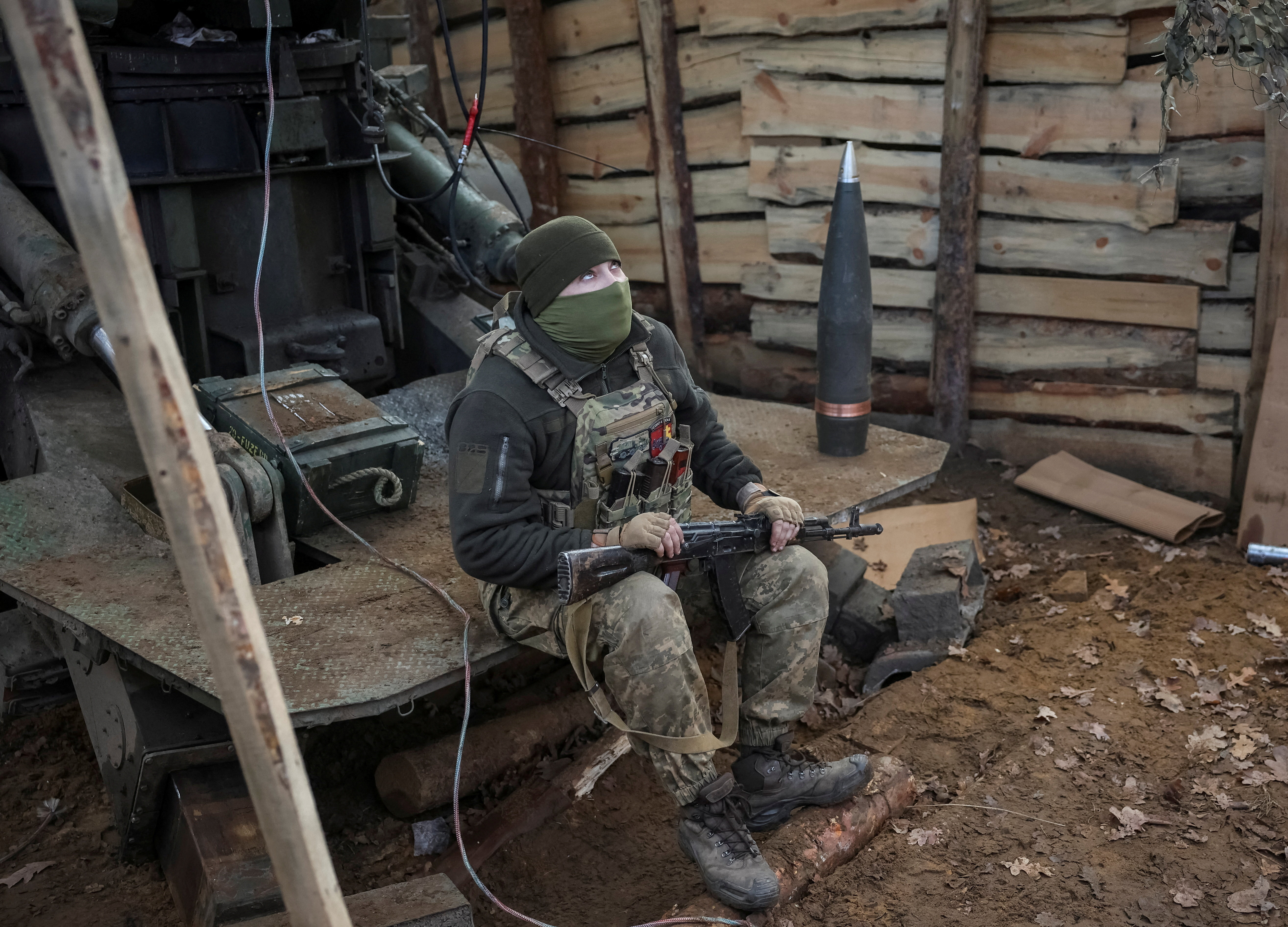 A Ukrainian soldier checks the sky for Russian combat drones at a position on a front line near the town of Kostiantynivka in the Donetsk region, Ukraine, on November 29, 2025 [Reuters]