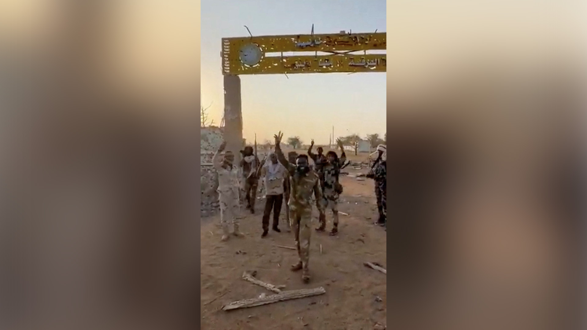 Members of Sudan's paramilitary Rapid Support Forces (RSF) stand in front of the main gate of the 22nd SAF Infantry Division, in Babanusa, Sudan, in this screengrab obtained from a social media video released December 1, 2025. [Social media via Reuters].