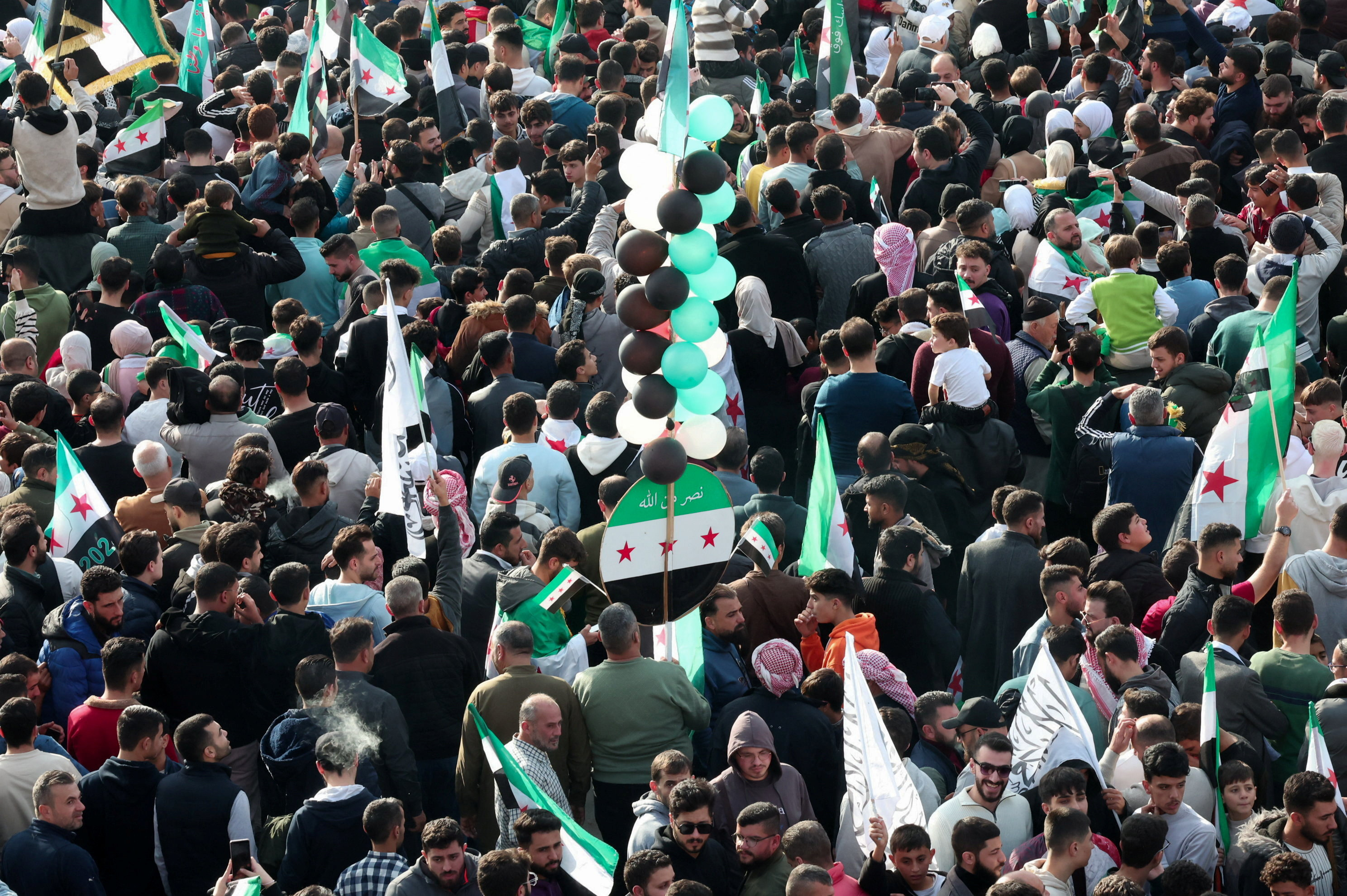 Residents of Hama gather during a protest to mark the first anniversary of the fall of Bashar al-Assad's regime, in Hama, Syria December 5, 2025.