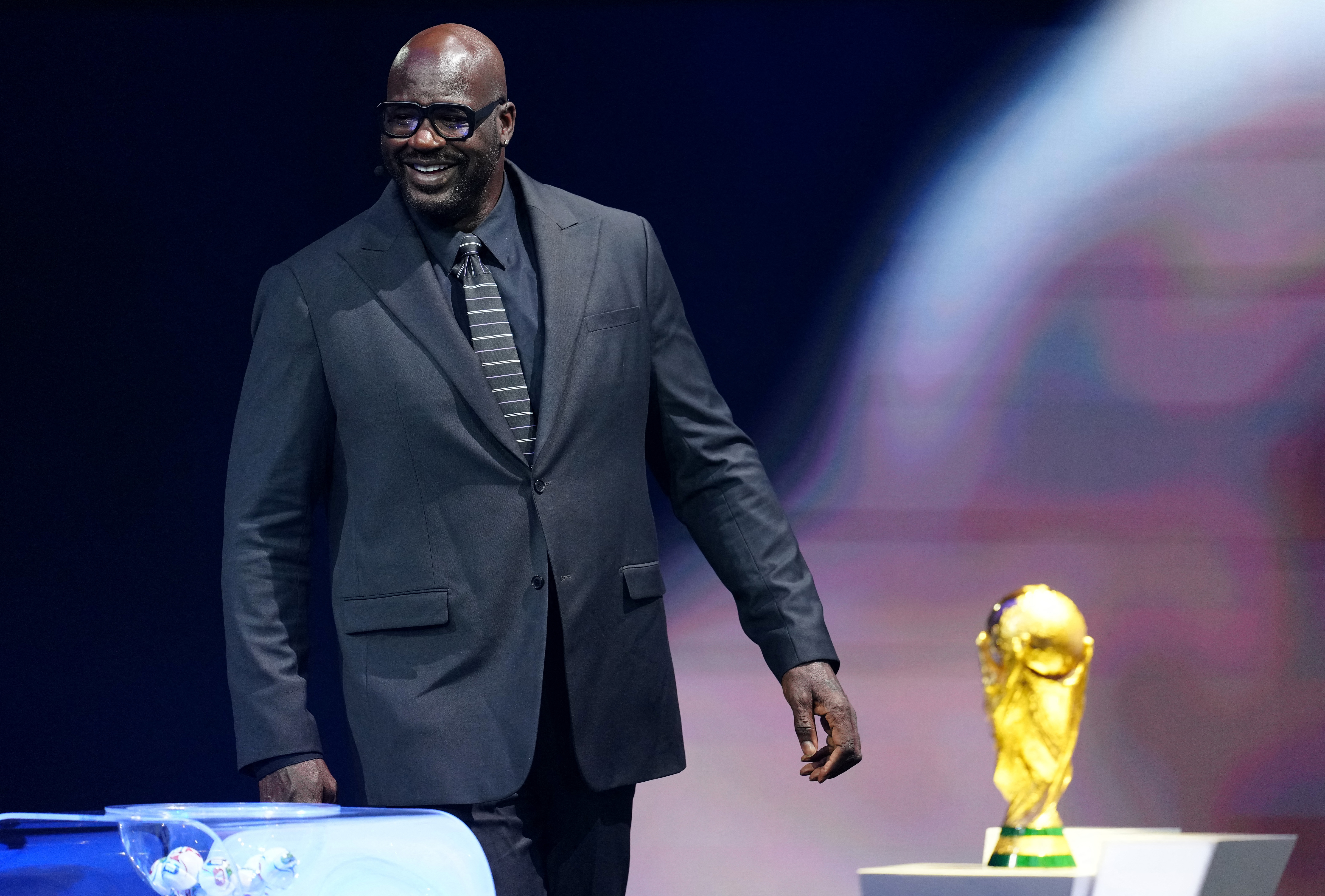 Soccer Football - FIFA World Cup 2026 - FIFA World Cup 2026 Draw - John F. Kennedy Center for the Performing Arts, Washington, D.C., U.S. - December 5, 2025 Draw Assistant Shaquille O'Neal with the World Cup trophy during the FIFA World Cup 2026 Draw Pool via REUTERS/Jia Haocheng