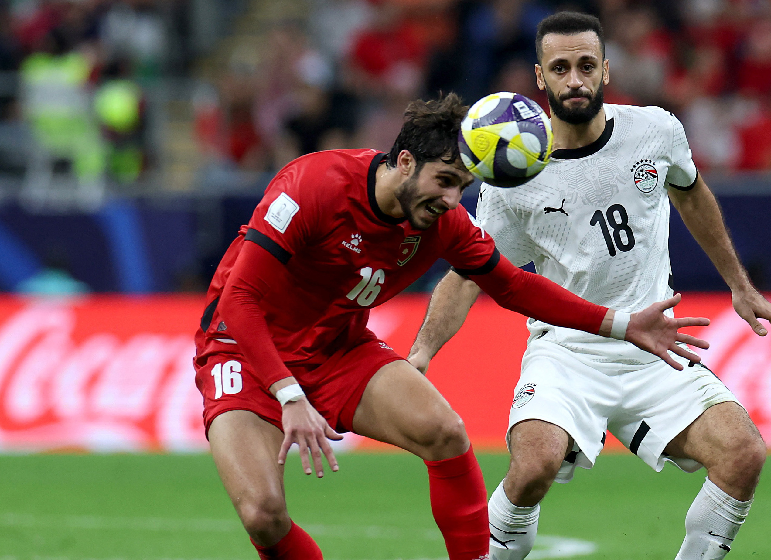 Jordan's Ali Hajabi in action with Egypt's Marwan Hamdy. [Ibraheem Al Omari/Reuters]