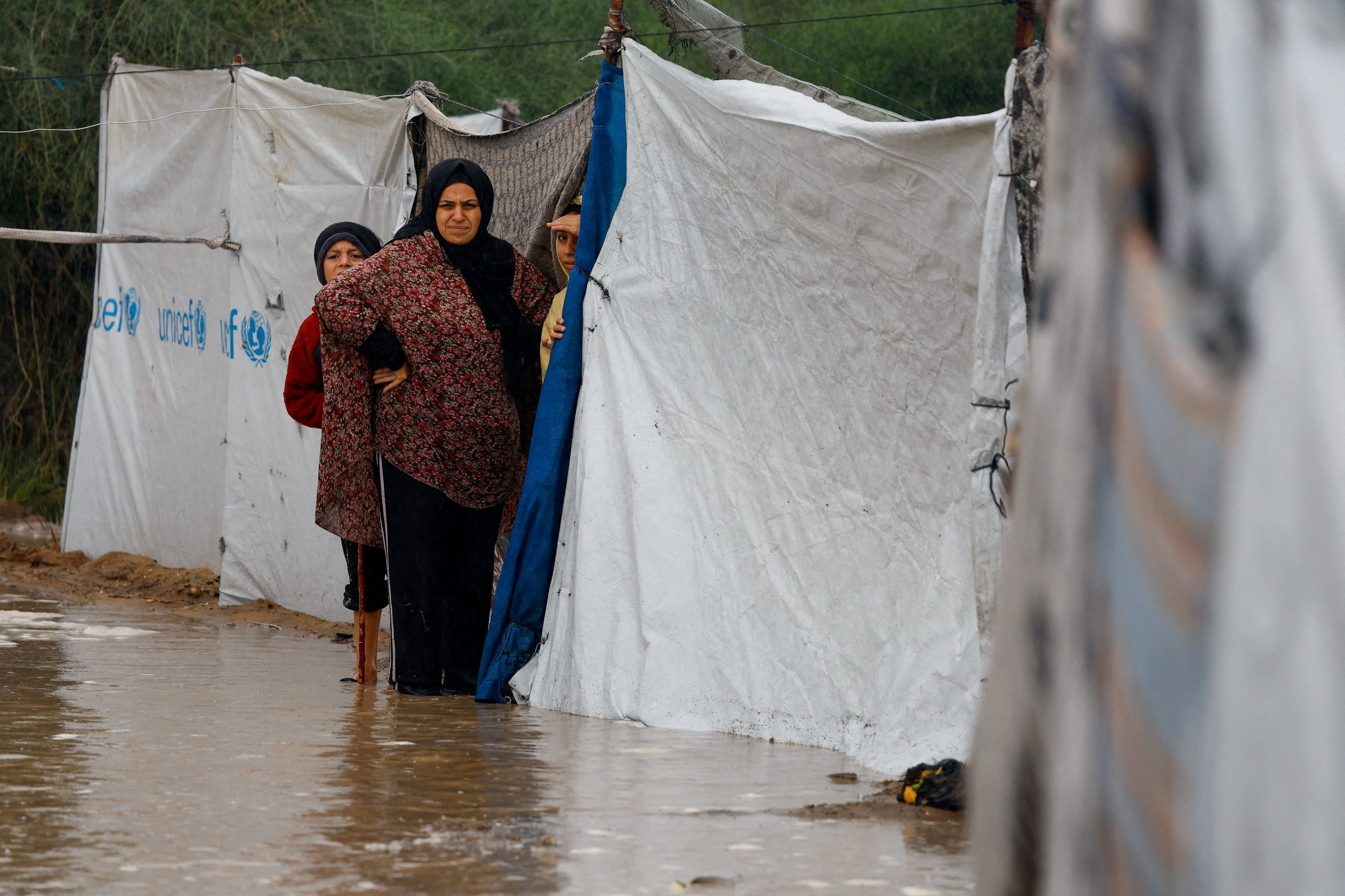 Palestinians stand by flooded tent