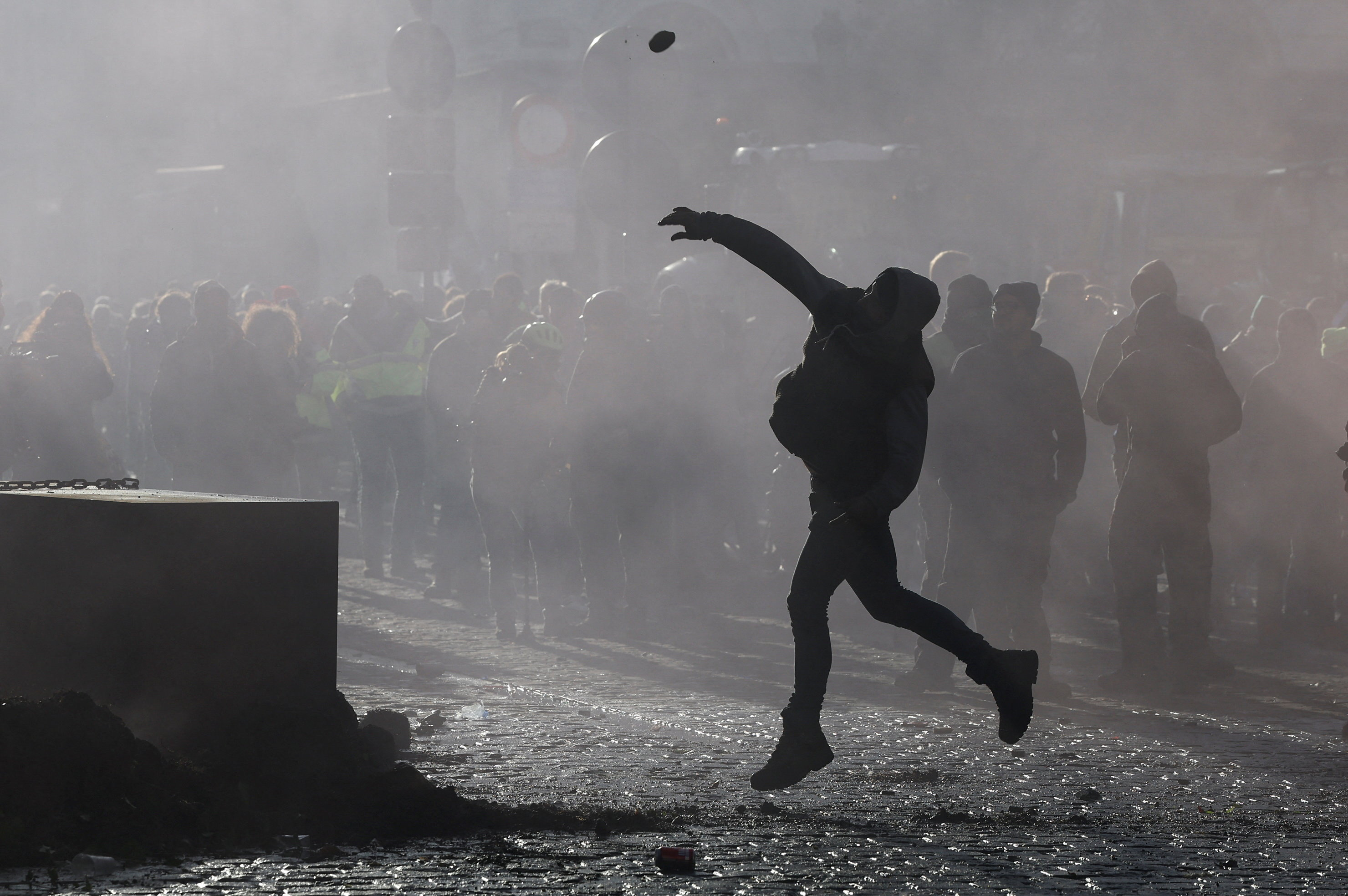 A protester throws an object, as farmers protest against the EU-Mercosur free-trade deal between the European Union and the South American countries of Mercosur, on the day of a European Union leaders' summit, in Brussels, Belgium, December 18, 2025. REUTERS/Yves Herman