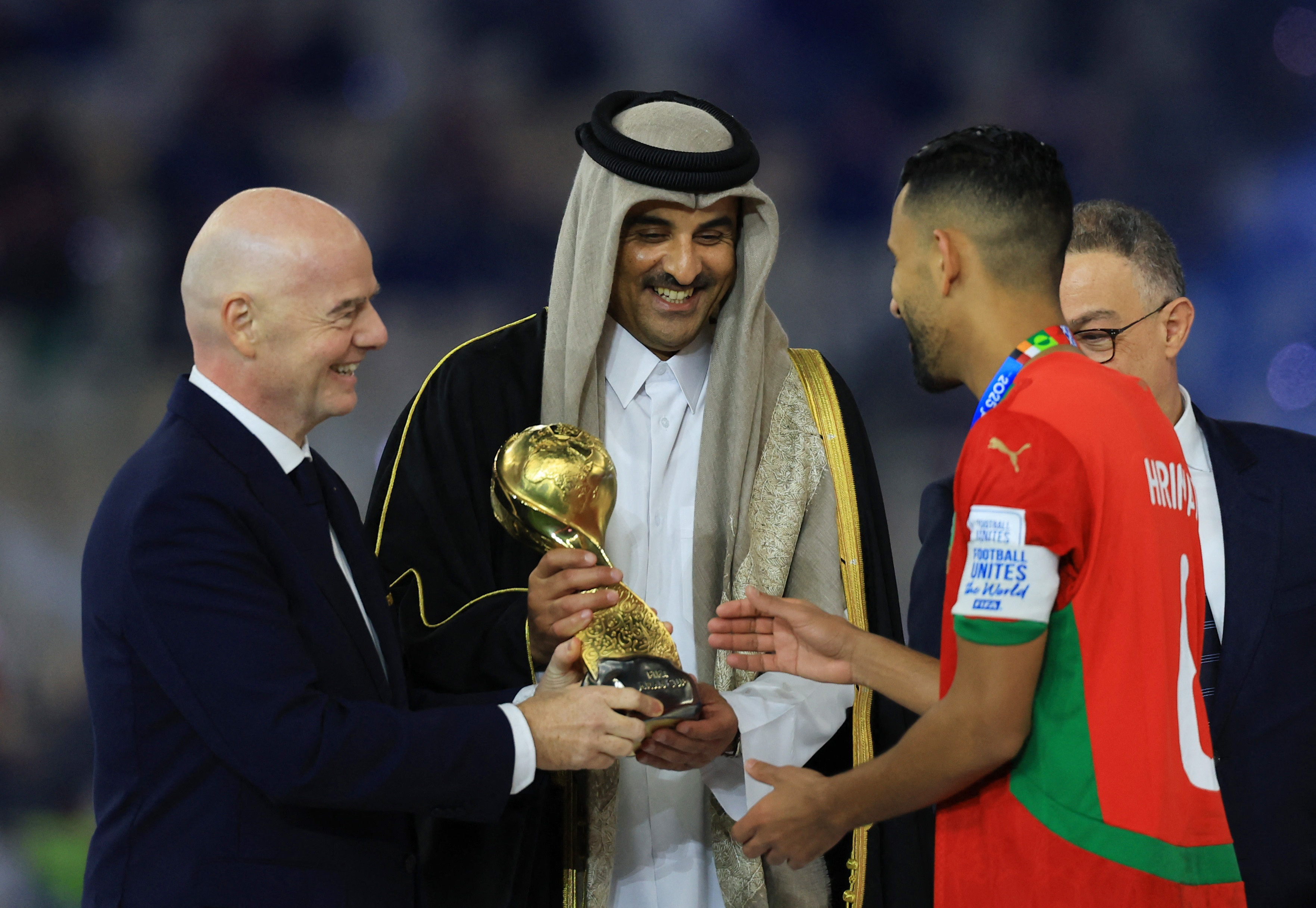 FIFA president Gianni Infantino and Emir of Qatar Sheikh Tamim bin Hamad Al-Thani hands the FIFA Arab Cup trophy to Morocco's Mohamed Hrimat on the podium
