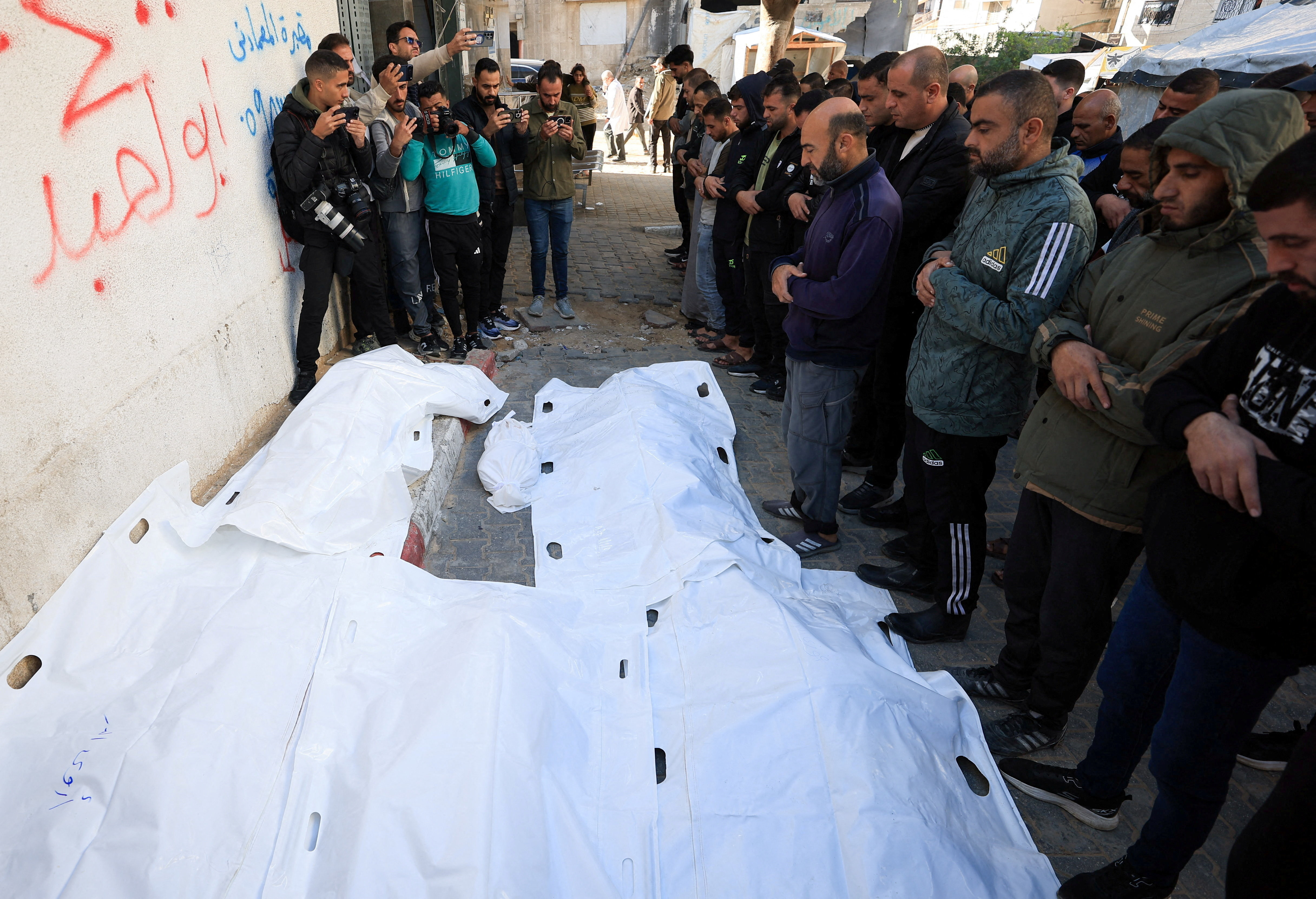 Mourners attend the funeral of Palestinians killed in an Israeli strike at Al-Shifa Hospital in Gaza City, December 20, 2025. [Dawoud Abu Alkas/Reuters]