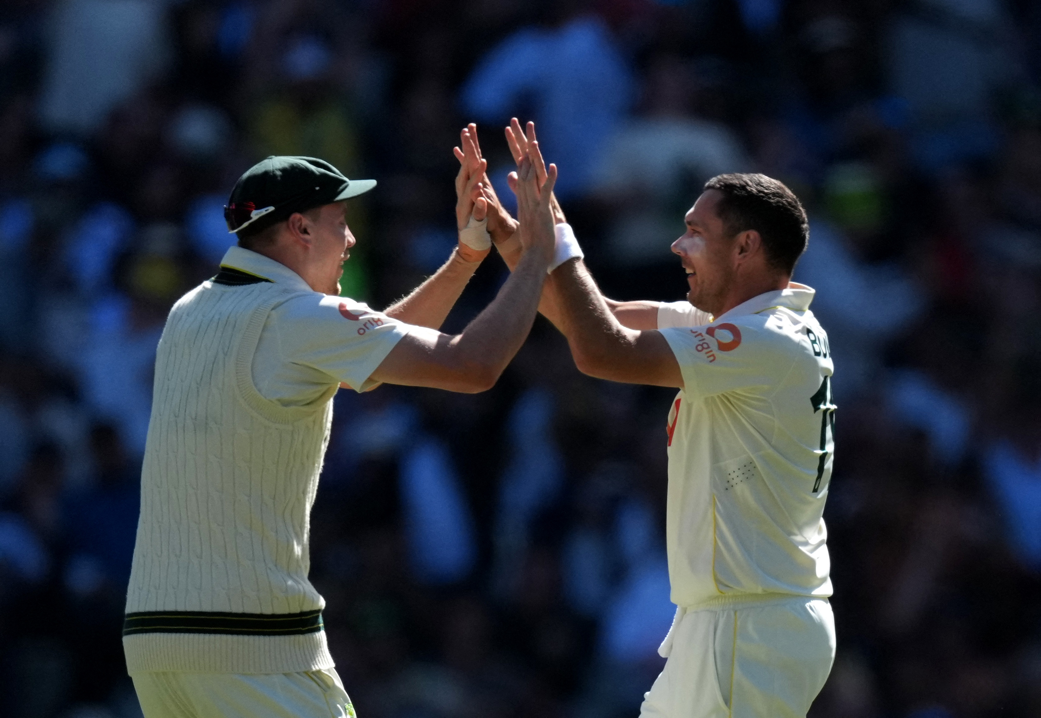 Cameron Green and Scott Boland react.