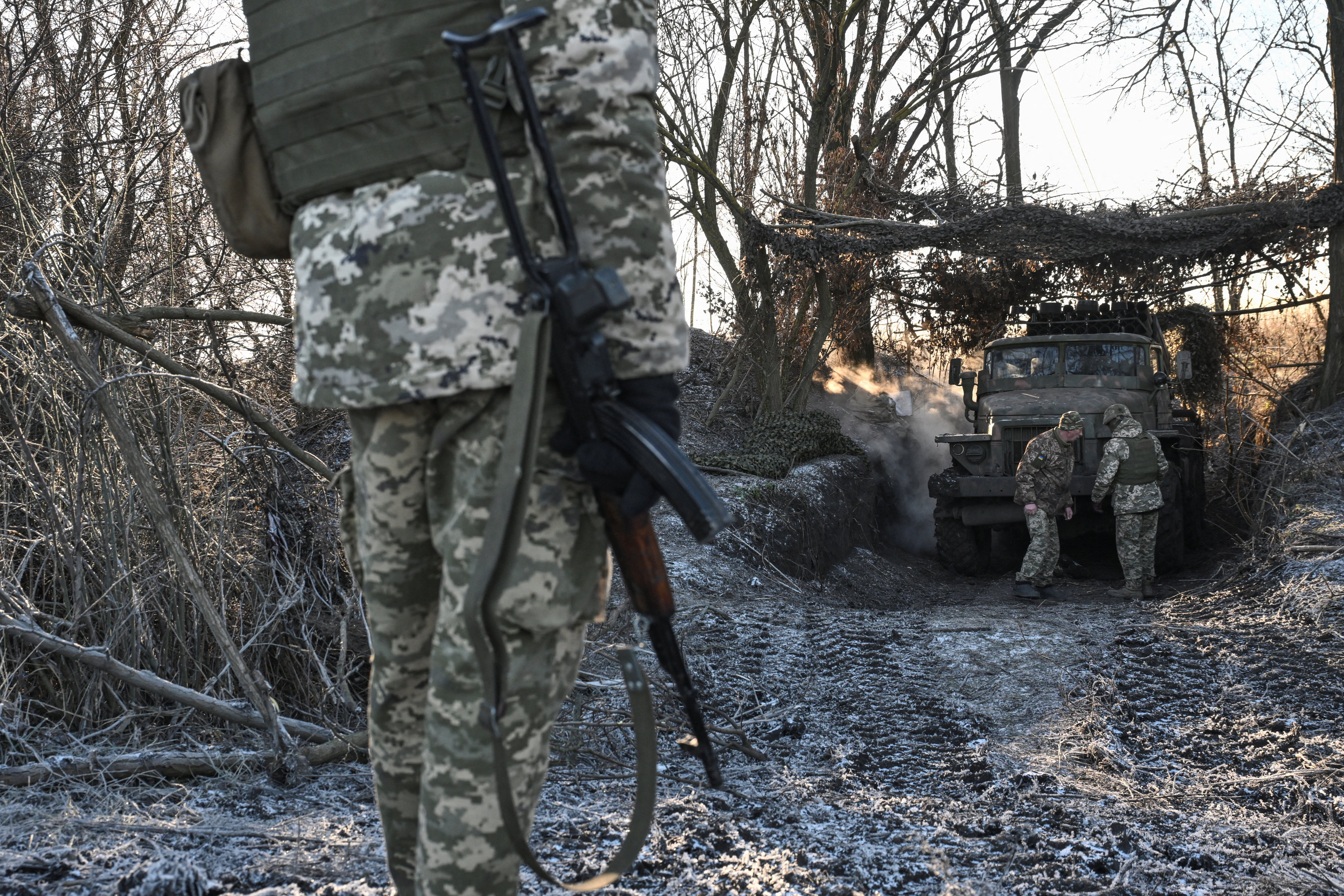 Service members of the 152nd Jaeger Brigade of the Ukrainian Armed Forces stand next to a BM-21 Grad multiple rocket launch system at their position in a front line, amid Russia's attack on Ukraine, in Donetsk region, Ukraine December 25, 2025. REUTERS/Stringer