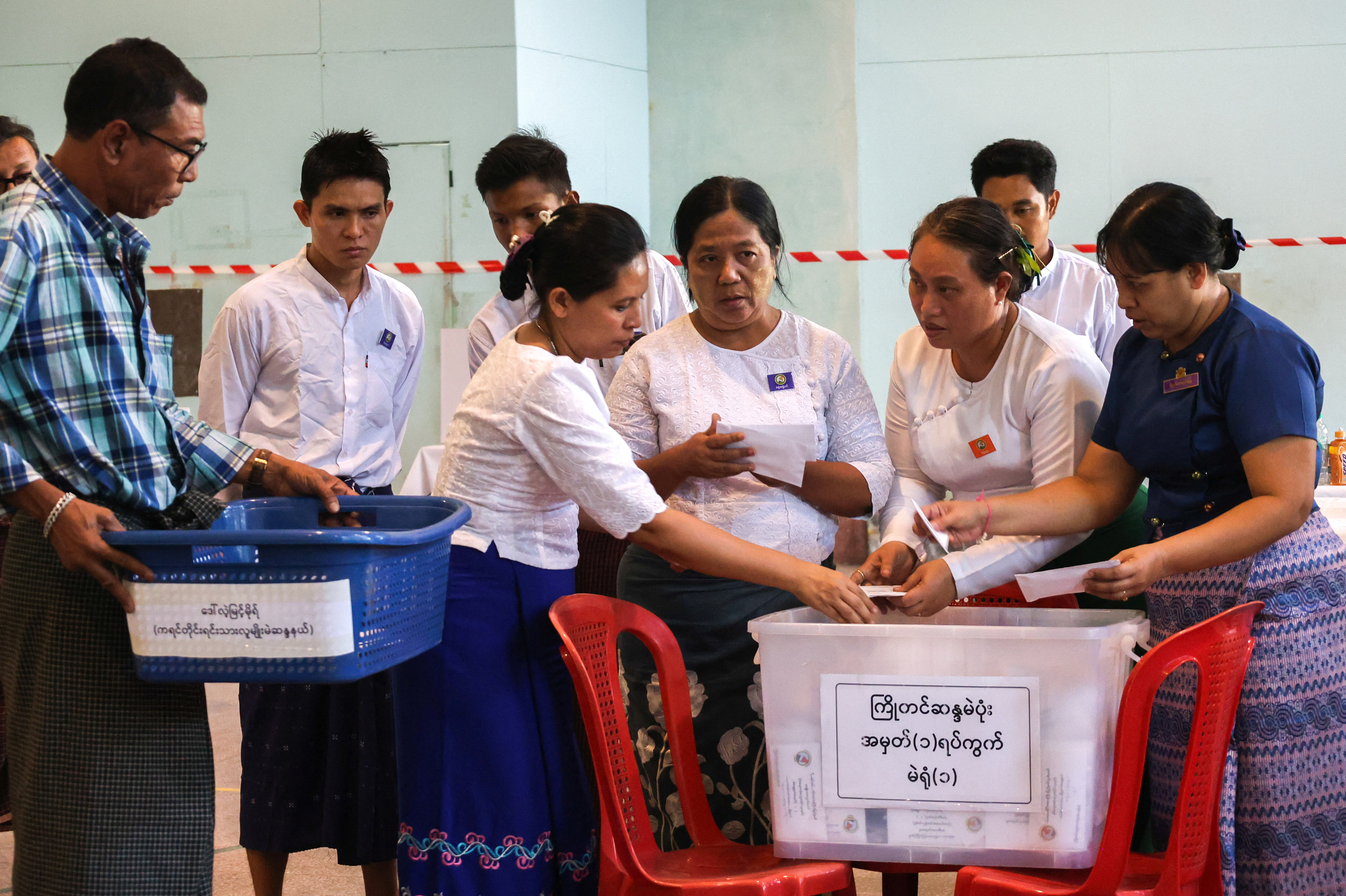 Election officials count ballots at a polling station during Myanmar's general election in Yangon