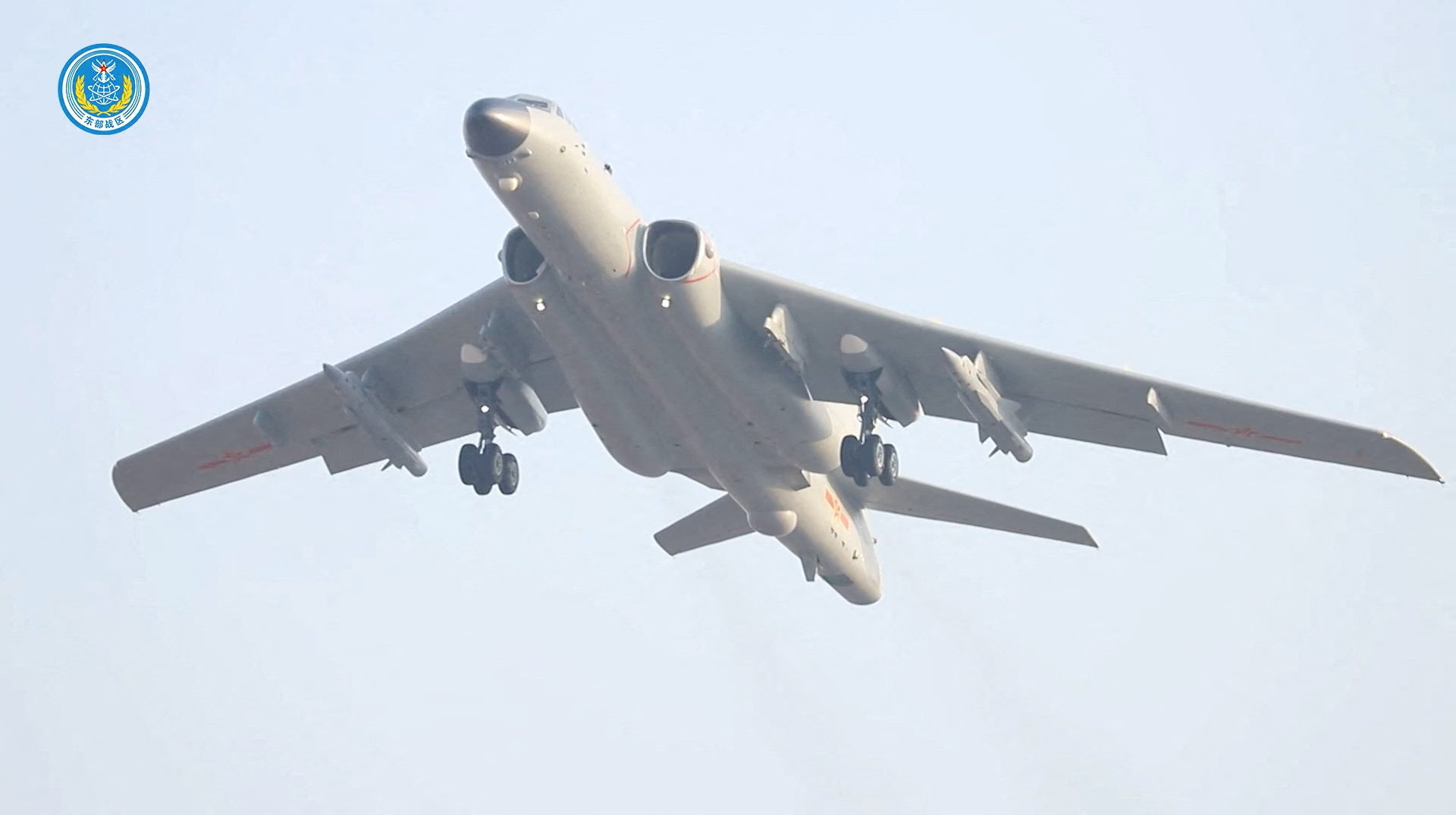 A bomber plane flies in the sky.