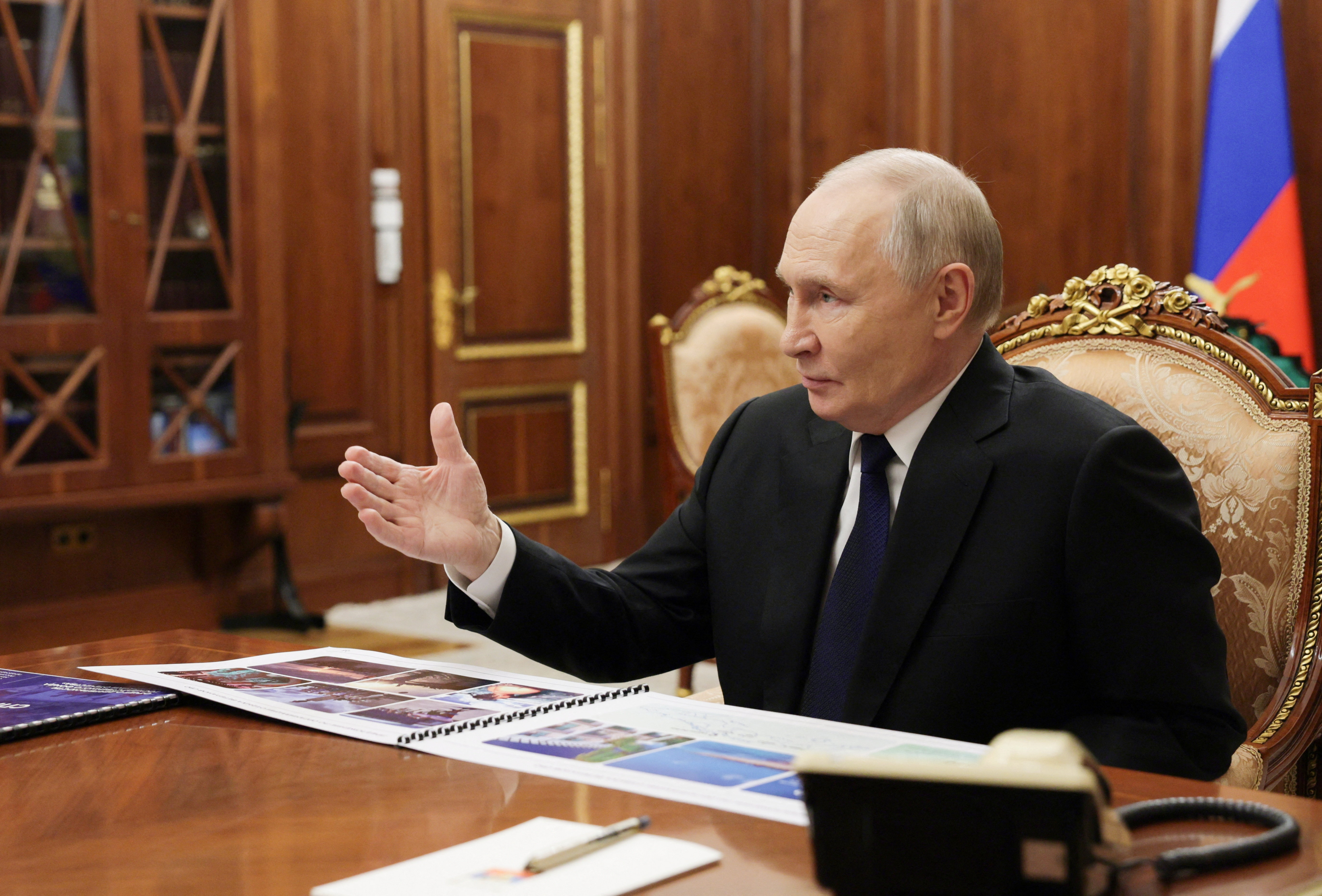 Russian President Vladimir Putin attends a meeting on Tuesday in Moscow [Mikhail Metzel/Pool via Reuters]