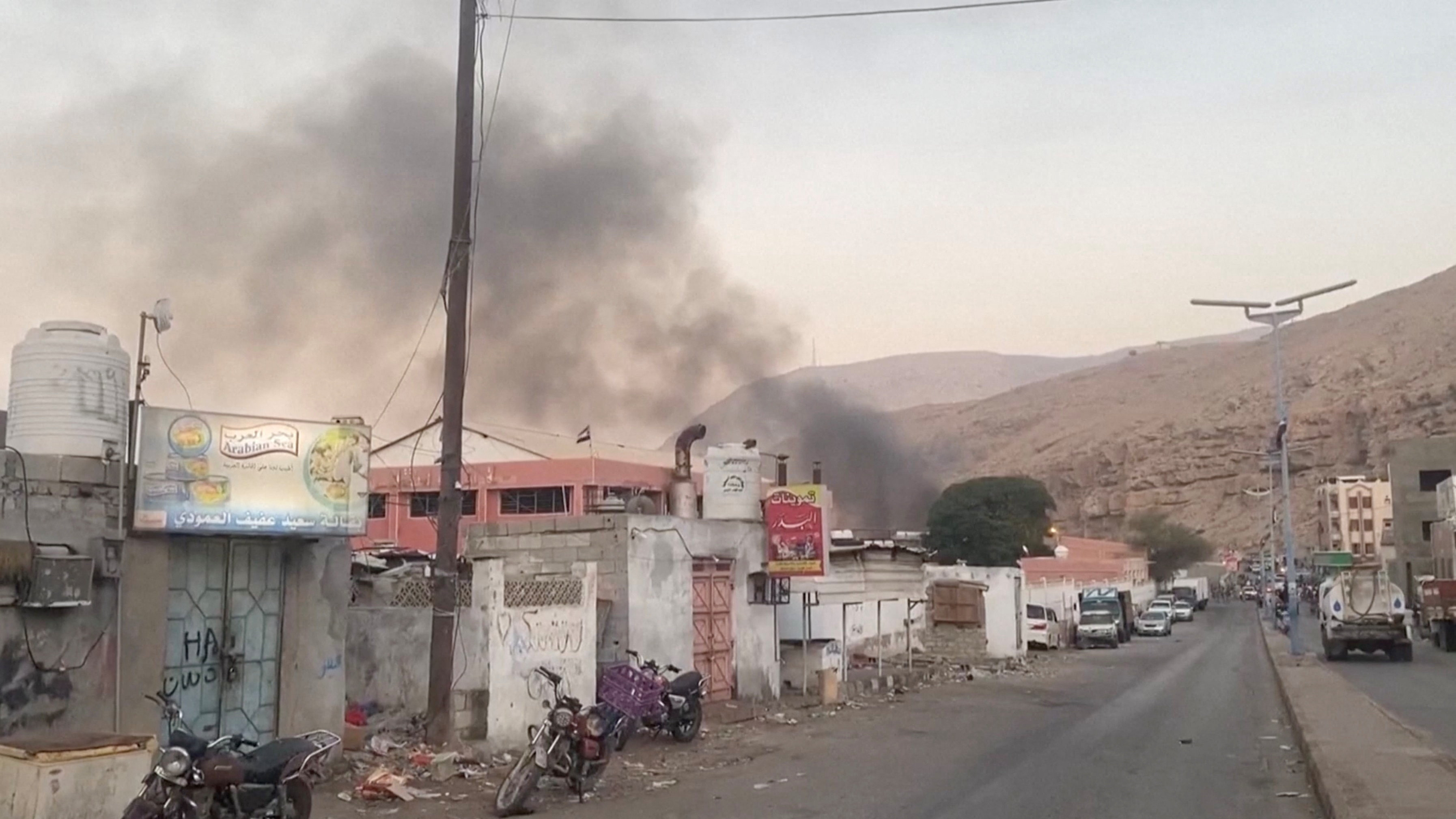Smoke rises in the aftermath of a Saudi-led coalition airstrike on Yemen's southern port of Mukalla, December 30, 2025. [SABAA TV/Handout via REUTERS]